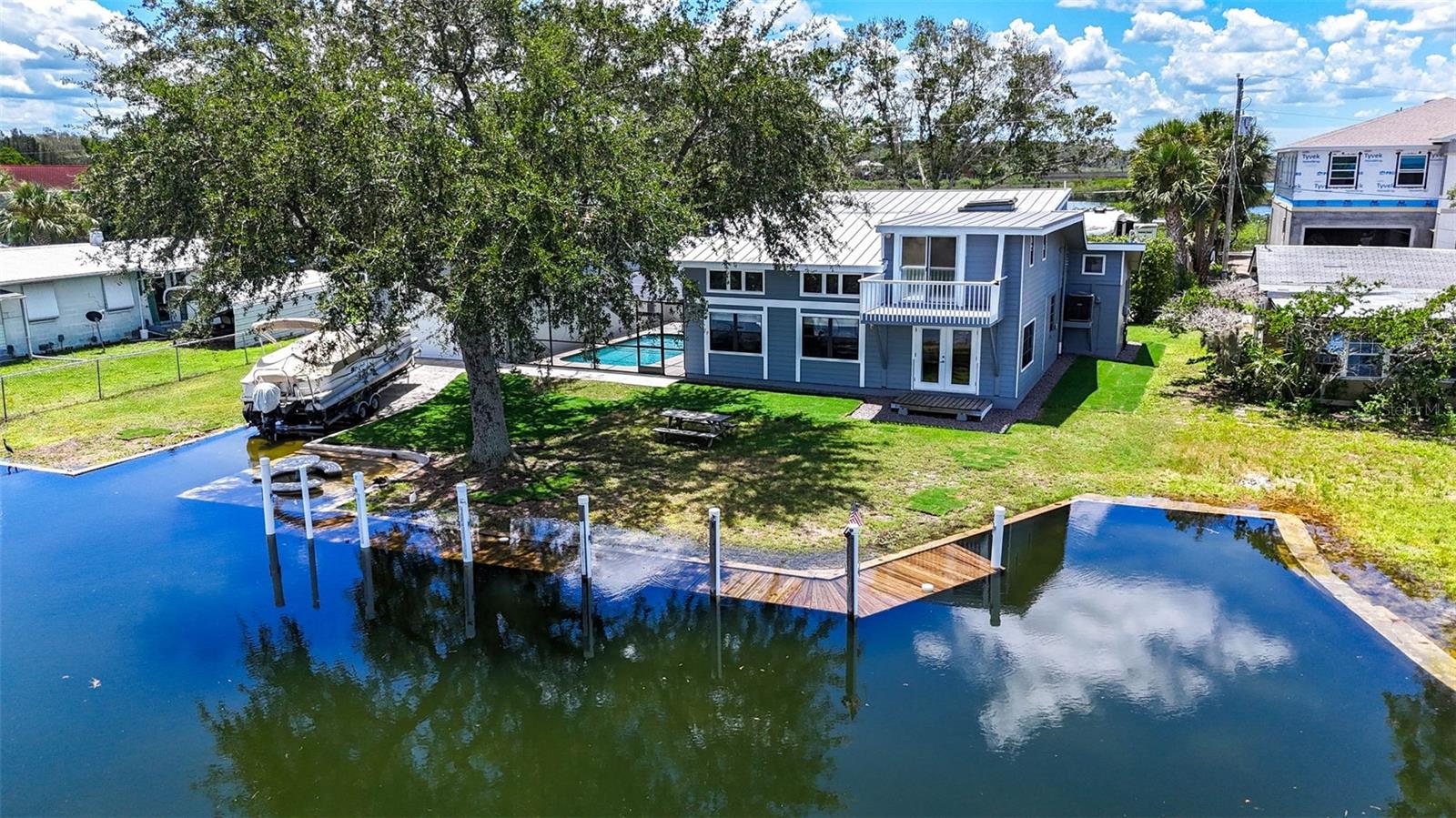 WATERFRONT and priced to sell! This beautiful home is sure to impress with it's unique character and custom built quality. Finishes and trim built with marine grade wood by a yacht builder, featuring timeless nautical finishes. This impressive block home includes three bedrooms and a loft office, 3.5 bathrooms, a screened in lanai, a balcony overlooking the Gulf, an inground screened in pool, a large drive-through boat house with it's own private boat ramp! A large dock with patio overlooking the water. Across the canal is nature vista views as far as the eye can see. Coastal breezes give a pleasant temperature and constant fresh air to enjoy while watching the manatees, dolphins, and abundance of wildlife. The sunsets are breathtaking. There is ample storage for boats, jet skis, kayaks, fishing equipment, and tools or toys. This home was previously a short term rental and could easily be used for income. Enjoy local marinas, waterside dining, shopping, golfing, state parks, hiking, fishing, and Weeki Wachee springs near by. Just 43 miles to the Tampa Airport. Schedule your private tour today!