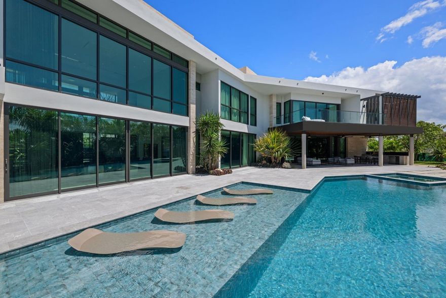 Experience the ultimate in resort-style living with this newly constructed and fully furnished luxury residence, located in the exclusive Dorado Country Estate lot 36 in Dorado. Perfectly situated on an elevated 2,419m² (approx.) a corner lot within an exclusive community, this property offers 8 bedrooms, 10 bathrooms, and an impressive 14,267 sq. ft. (approx.) of gross floor area, thoughtfully designed to combine elegance, comfort and functionality.
The air-conditioned interior includes 9,573 sq. ft. (approx.) of main living space and 1,033 sq. ft. (approx.) of garage. Additional covered spaces include 894 sq. ft. (approx.) of covered terraces and 91 sq. ft. (approx.) of utility rooms. Outdoor areas add another 2,201 sq. ft. (approx.), plus 475 sq. ft. (approx.) of dedicated utility area, creating a resort-like retreat ideal for both indoor and outdoor living. A private elevator, premium finishes and three integrated control panels further elevate the living experience.
Equipped for both luxury and self-sufficiency, the residence features an 80 kW generator, three solar water heaters, two 900-gallon cisterns, a water softener and 10 exterior security cameras. Electric blinds and a premium sound system indoor and outdoor ensure maximum comfort. The property features Airmaster windows and doors, tested and certified to withstand impacts, water infiltration and hurricane force winds.
The exterior is equally remarkable, boasting spacious terraces, lush gardens with professional irrigation and lighting, a resort-style swimming pool and a versatile jacuzzi that can be enjoyed heated for relaxation or as a refreshing cold plunge bath. A three car garage plus golf cart space complements an incredible 4,900 sq. ft. (approx.) paver driveway, offering a spectacular entrance and abundant parking.
Located within Dorado’s most sought-after community, this home offers not only resort-inspired amenities but also the security and exclusivity of Dorado Country Estates, with a monthly HOA fee of $488.