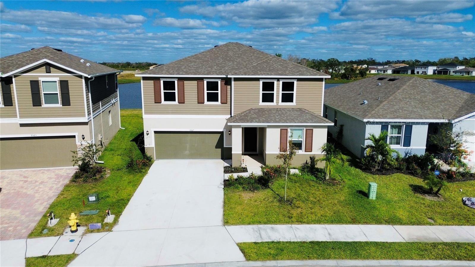 This stunning 1-year-old home has everything you could want! Situated on a rare water-view lot, it features 9-foot ceilings, a first-floor bedroom with its own full bathroom, a spacious great room, and an extended covered patio with no neighbors behind. The kitchen is a chef’s dream, equipped with a large eat-at island, 42-inch upper cabinets topped with crown molding, granite countertops, a brick-laid subway tile backsplash, a pantry, and a stainless-steel Whirlpool appliance package. Upstairs, you’ll discover three additional bedrooms, each with its own closet, plus a dedicated laundry room. The primary suite offers a generous walk-in closet, and its attached bathroom includes a linen closet, a raised dual-sink vanity with granite countertops, and a walk-in shower with tile surround. The community provides easy access to US-301, I-75, and I-275, making commuting a breeze. Don’t miss this incredible opportunity!