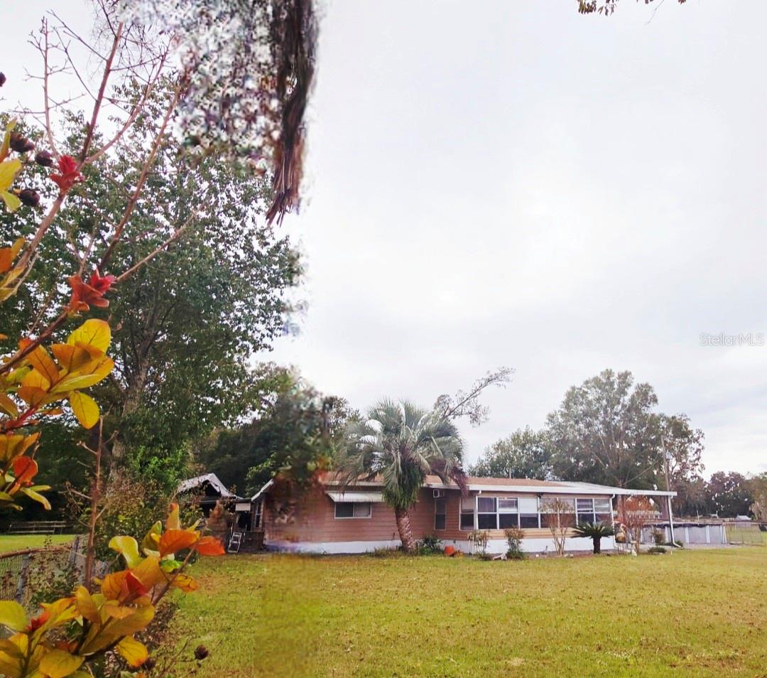 The perfect family Compound set-up! 2 homes located on 2.24 acres fenced and ready for new owners. This setup would make the perfect family compound or investment property with 1981 Skyline doublewide manufactured home that has 2 bedrooms 2 bathrooms, carport, tile floors, enclosed lanai on the front, open back porch area, above ground pool with deck and BONUS camper trailer that can be used for storage area. The 2nd home is a 1993 Destiny singlewide manufactured home with 2 bedroom 1 bathroom currently with month to month lease. Each home is fenced separately and a large area completely fenced around both sides and back of main home that could have farm animals of your choice as this property is zoned A1 or a nice size garden area. This property has opportunities with family as main home and in-law set up or rental units as income property. Located close to The Villages and easy commute to Ocala, Orlando or Tampa. A must to see. Beautiful location