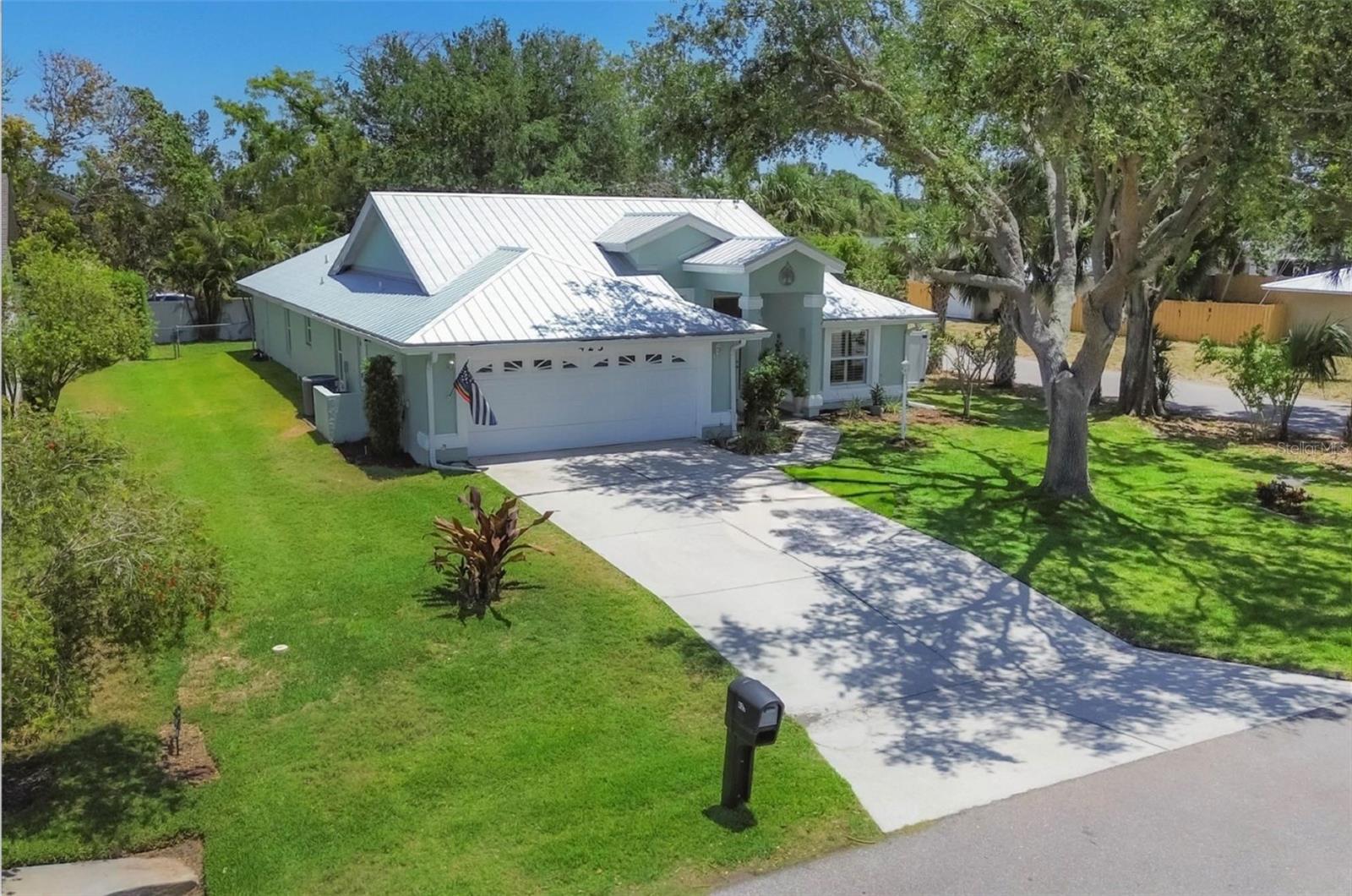NW Bradenton Beauty! Step into this GORGEOUS 4 bedroom, 2 bathroom home that offers a balance of comfort and elegance ideally located in a non-deed restricted neighborhood with room to park your boat on the side of the house. The heart of the home is a chef's dream kitchen outfitted with a high-end Thermador gas range, double oven, quartz countertops, barstool counter, a kitchen island made for hosting, a charming breakfast nook overlooking the front and almost all 2017 KitchenAid stainless steel appliances. This is the perfect set up for entertaining family and friends! The primary bedroom offers excellent space for your furniture needs with a stunning bathroom tastefully remodeled that includes an attractive glass walled shower situated next to the soaking tub. Extra amenities reflect custom double entry glass doors, plantation shutters, ceramic wood look plank tile floors throughout, taller kitchen cabinetry, soft close drawers and cabinets and coveted additional custom cabinetry in the breakfast nook area for your extras. The formal dining room is well sized with room to easily accommodate your breakfront and hutch. The family room is large and accented by crown molding and a cathedral ceiling. Relax, watch tv and kick back or head out through the two sets of double French doors to the enclosed covered lanai where you can read your favorite book, drink your favorite beverage and enjoy the privacy of a backdrop of Areca Palms bordering the vinyl fenced backyard. This home has gracious mature oak trees watered by a well with a 1 HP Gould pump. The sprinkler system set on a timer will help keep the landscape lush and green for you. This home is built to provide peace of mind with American Craftsman impact windows and aluminum hurricane shutters for the front door, patio door and primary suite French doors. A 2016 Trane A/C and a 7 year old metal roof all offer long term protection. Located in an X non-flood zone. Live your lifestyle with no HOA restrictions!