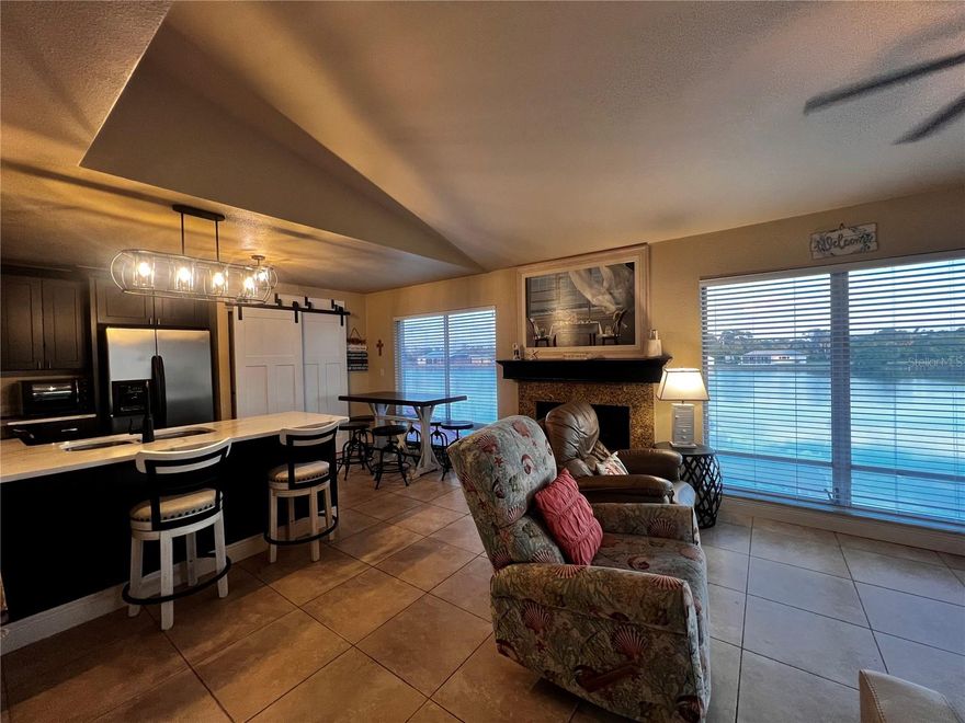 Welcome to this light, bright, and beautifully maintained 2-bedroom, 2-bath second-floor condo offering peaceful lake views and just under 1,000 sq ft of comfortable living space. Sold FURNISHED/TURNKEY, this clean and tidy home features tile flooring throughout, making it perfect for full-time living or a low-maintenance seasonal retreat.

Enjoy the airy feel of volume ceilings in the main living area, a spacious kitchen with a breakfast bar and abundant cabinet storage, a cozy dinette space, and an inviting living room with sliding glass doors that open to the screened lanai overlooking the lake. The interior stackable washer and dryer add extra convenience.

The large primary suite also features sliding doors to the lanai, allowing you to wake up to serene water views. The guest bedroom is warm and welcoming, offering a generous walk-in closet for storage and is close to the 2nd bathroom with tub/shower combo.

Located in a friendly community with a low HOA fee that includes water, trash and access to the community pool, and your own parking spot, this condo is designed for easy living. Relax by the pool, unwind on your lanai, or explore all that Punta Gorda has to offer—charming downtown shops, farmers markets, waterfront parks, restaurants, and scenic walking & biking trails along the harbor.

With quick access to US-41 and I-75, this condo is perfectly situated for both convenience and relaxation. A delightful opportunity for seasonal residents, investors, or anyone looking to enjoy the Florida lifestyle with beautiful lake views. Call today for a showing.