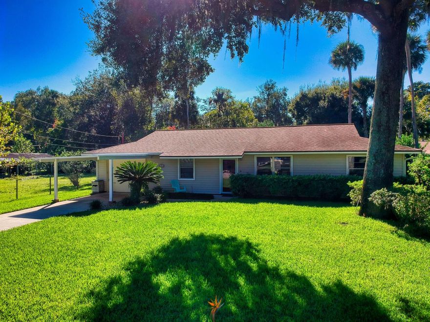 This adorable, well cared for family home comes with a completely updated, quality interior that is a must see! It’s a 3-bedroom, 2-bathroom home with a large bonus room and relaxing Florida room to enjoy that cup of morning joe, evening sunsets and everything in-between. The spacious owner’s bedroom comes with an oversized walk-in closet and custom built-in shelves. The kitchen and bathrooms boast real wood shaker cabinets with custom pull-outs and soft closures. Enjoy new “Smart” black stainless-steel appliances, Quartz and Corian countertops, classic subway tile in bathrooms, and beautiful Moen faucets/shower hardware (2019). High mil-wear NuCore LVT flooring with cork backing and moisture barrier and fresh interior paint grace the entire home. Additional updates and attention to care include a recent septic clean out and inspection; a 30-year roof added to the carport last year and 30-year roof added to the main home in 2013; a new well pump in 2018 for the in-ground sprinkler system. The large utility/laundry room has additional space for an office, crafts, and storage. The lush yard is well maintained with a large oak tree, king sego palms and birds-of-paradise. There’s no HOA restrictions and plenty of room for a pool and/or to park the toys. Centrally located in the heart of New Smyrna Beach, this unique home with modern features and a large yard in a homey neighborhood is perfect for families and people of all ages! Appreciate convenient proximity to I-95, SR-44, and great beaches…all while enjoying the tucked away privacy in a well-established neighborhood. ;Water: City