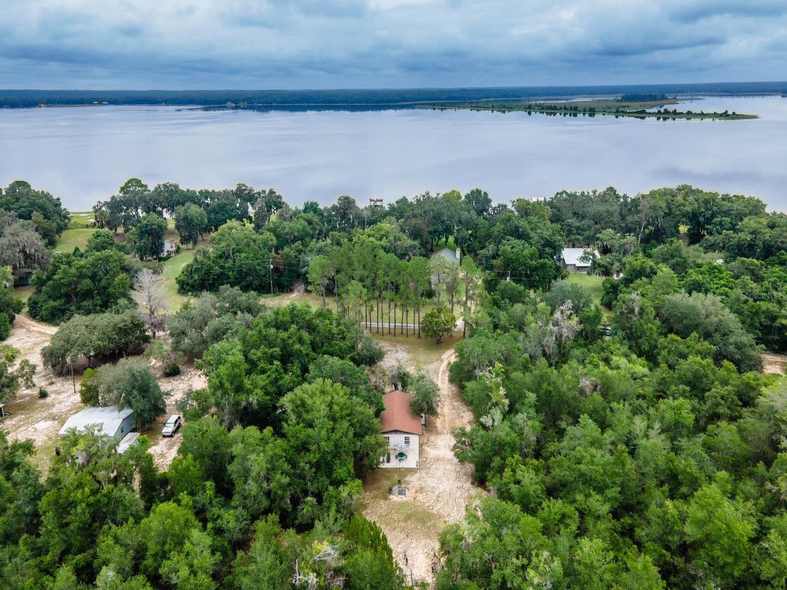Escape to the serene beauty of Salt Springs and Lake Kerr. Nature Lovers dream of places like this. Birds abound! Eagles, osprey, owls, turkey, sandhill cranes and blue herons. Discover this charming 2-bedroom, 1-bath single-family home nestled on .60 acres including Lake Kerr access lot in walking distance of the property and lots of trees providing great serenity. This concrete block home features 864 square feet of living space, offering a comfortable layout with a spacious family room including 2 large picture frame windows, and a kitchen with breakfast bar, range and refrigerator. Also comes partially furnished. The property features septic, well, and electric HVAC with a heat pump. There’s plenty of space to expand or personalize the lot’s .60 acres with no HOA restrictions and no annual association fees.
**NOTE** This is a United States Forest Service Recreational Residence lease property. Property is “As-Is”, About US Forest Service Recreational Residence Leases -- Full time residency is NOT allowed. Renting the property is NOT allowed. Buyer is responsible for annual property taxes, the annual Forestry lease fee and a one time transfer fee. The way this works is the cottage, and any personal property is purchased cash or conventional and delivered by “Bill of Sale”. The remaining land lease is transferred to the buyer by the US Forestry Service. This land is under the Federal Recreation Residence program and leased under a special use permit. See docs attached for US Forestry service rules and Regulations. Annual lease fee is currently $2,400, the annual taxes are currently $300 and there is a transfer fee (one time)- $1,302. Basically, the structures on the land are owned by the seller, but the land itself is leased to the seller by the US Forestry Service. This transfer process from seller to buyer can take some time. The first order of business is all the funds to close are placed in escrow with the title company and the buyer then makes application with the Forestry Service to transfer the existing special use permit. The Forestry Service inspects the cabin for compliance to the lease terms, and requires corrections, if any, be performed and reinspected before moving forward. The transfer is then approved locally and then sent to Tallahassee to be signed and returned, which can take weeks. The funds are then disbursed, and keys delivered to buyer when the permit comes back.