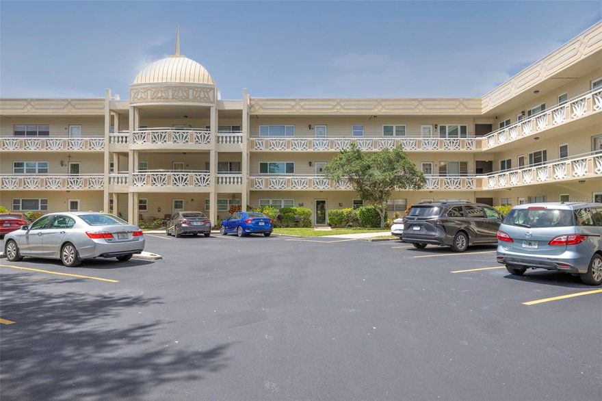 Located across the street from Hole 1 for both golf courses, this beautifully Emerald (model) updated condo with newer impact windows and HVAC system, offers a welcoming and functional layout in a highly desirable 55+ community! Your monthly fee covers everything except your electric, the epitome of hassle free Florida living! The kitchen features stainless steel appliances including a microwave, stove, and side-by-side refrigerator. along with granite countertops, a tile backsplash, a double sink, and elegant wood soft-close cabinetry. The kitchen space is thoughtfully designed and includes room for a small table and chairs. As you enter, you’ll find two spacious closets off the main hallway, ideal for extra storage and pantry space. To the right is the kitchen, while straight ahead opens into a bright and airy great room with an additional bonus space overlooking a peaceful courtyard. Large rear windows fill the living and dining areas with natural light. Off the living room, a hallway leads to the guest bedroom and primary suite. Along the way, you'll find another storage closet housing the hot water heater, plus additional hallway storage, including a linen closet with built-in shelving. The guest bedroom offers a large wall closet and an oversized updated window, creating a bright and inviting space. The guest bathroom has been tastefully updated with gray cabinetry and features a step-in shower with glass doors. The primary suite includes multiple closets for ample storage and a spacious bedroom with large windows overlooking green space. The en-suite bathroom features an updated vanity with stone countertops and a step-in shower with sliding glass doors. Laminate wood flooring runs throughout the main living areas and bedrooms, while tile flooring is found in the kitchen, bathrooms, and entryway. Located in the highly sought-after On Top of the World community in Clearwater, residents enjoy a wide array of amenities including 2 golf courses, 2 pools, clubhouses, a gym, shuffleboard, pickleball, tennis, and a full calendar of activities and clubs to be involved in. Conveniently situated near beaches, shopping, dining, and major routes to St. Petersburg and Tampa. The shared laundry room is just one unit away on the same floor, adding to the home’s everyday convenience. Pets are welcome, including large dogs!  The home can be sold furnished and turnkey!