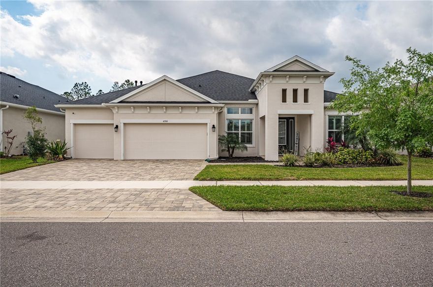 Price Reduction with a $10,000 Buyer Incentive! Step into your dream home — a breathtaking 2022-built Cardel property where stunning water and conservation views create a picturesque backdrop to everyday life. Designed to blend elegance with functionality, this residence welcomes you with an expansive open floor plan and soaring 12-foot ceilings, setting the stage for both relaxation and entertaining. At the heart of the home, the chef’s kitchen is a masterpiece of design, featuring stacked solid wood cabinetry, exquisite granite countertops, a stylish tile backsplash, and a large central island illuminated by elegant pendant lighting. Built-in stainless steel appliances, a gas cooktop, and a spacious pantry ensure effortless meal preparation, while the seamless flow into the great room, breakfast nook, and formal dining area makes hosting gatherings a delight. The entryway and dining room exude sophistication with coffered ceilings and board-and-batten accents, while ceramic flooring throughout the main living spaces enhances the home’s refined aesthetic. A dedicated office with French doors near the front entry provides a quiet, functional space ideal for remote work or personal projects. This exceptional home boasts two luxurious master suites, each with oversized windows framing serene views. The primary suite features dual custom walk-in closets and a spa-inspired ensuite with separate vanities, a grand walk-in shower, a tile-enclosed soaking tub, solid wood cabinetry, and granite countertops — the perfect blend of elegance and relaxation. The secondary suite offers an equally impressive private retreat with a spacious walk-in closet and spa-style ensuite with a generous walk-in shower. Two additional bedrooms share a well-appointed Jack-and-Jill bath with solid wood cabinetry and granite countertops. Step outside to the extended open lanai, where upgraded pavers, a gas hookup, and water lines await your dream outdoor kitchen. Panoramic views of the natural landscape make this space ideal for enjoying Florida’s beautiful weather. The backyard is a blank canvas ready for the custom pool you’ve always envisioned. The laundry room includes an oversized washer and dryer on pedestal bases and is pre-plumbed for a sink. Premium upgrades are found throughout, including plantation shutters, motorized shades in the great room, solid 8-foot wood doors, recessed lighting, and custom stonework. The oversized three-car garage features insulated, wind-rated doors and overhead storage racks. Additional highlights include a tankless water heater, water softener, impact-rated windows and doors, keyless garage access, a full-yard reclaimed water irrigation system, a fully fenced backyard, hurricane shutters, and security cameras for peace of mind. Enjoy resort-style amenities just a short walk or golf cart ride away, including a clubhouse with on-site café, three resort-style pools, a state-of-the-art fitness center, game room, scenic walking and biking trails, dog park, and playgrounds. Top-rated Bexley schools are conveniently nearby. Listing agent is co-owner of this property. Schedule your private showing today!