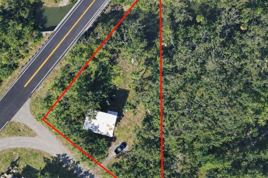 ***Rare Creekfront Investment Opportunity on Nearly 1 Acre | Redevelopment or Rehab Potential*** Opportunites combining acreage, natural features, and redevelopment potential are becoming increasingly rare in this area. Parcel boundary overlay demonstrates flexible redevelopment footprint with Bayshore Rd. exposure and secondary access positioning. 

Exceptional opportunity to acquire approximately 0.81 acres in Palmetto featuring a unique parcel layout with a portion of the property extending through scenic Frog Creek. This distinctive homesite offers a rare combination of size, natural surroundings, and redevelopment potential in a growing Manatee County location (buyer to verify all feasibility).

The existing structure sustained storm-related damage (NO FLOODING BUT WIND AND TREE DAMAGE). INTERIOR ACCESS NEEDS TO BE COORDINATED WITH LIST AGENT, DO NOT ATTEMPT TO ENTER THE HOME WITHOUT THE PROPER PROTOCOL> SEE REALTOR REMARKS..

The generous lot size and creek frontage create opportunities for creative design, privacy-focused builds, or long-term investment strategies. 
Bring your vision and unlock the potential of this unique property. Property is being marketed primarily for land value and presents multiple potential pathways for investors, builders, or contractors, including redevelopment, new construction, or full-scale renovation. Property sold strictly AS-IS. Cash or specialized financing recommended. Buyers responsible for all due diligence including zoning, environmental considerations, setbacks, and buildability.