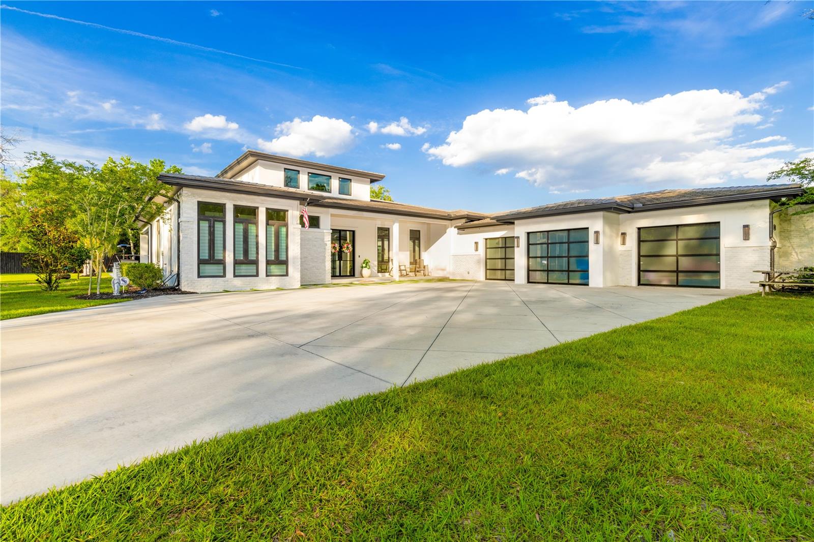 **Luxurious Living at 5546 Drexel Road** Welcome to your dream home at 5546 Drexel Road, a pristine estate sprawling across 2.45 lush acres, offering an unparalleled blend of luxury, comfort, and exceptional amenities. This exquisite property features 5 bedrooms, 4.5 bathrooms, a dedicated office, a 3-car garage, and a stunning in-ground swimming pool, marble & hardwood flooring that blend together seamlessly. These touches create the perfect backdrop for both lavish entertaining and tranquil relaxation. This home is equipped with remote-controlled window shades, a large mudroom with a cast-iron farmhouse sink, frosted glass garage doors, a custom wine closet, a custom walk-in pantry, closet systems in all closets, and LED lighting. A 250-gallon propane tank powers the range, pool heater, spa, and whole-home Generac generator, ensuring comfort and convenience at all times. As you approach via the expansive concrete driveway, the home’s grandeur welcomes you with a charming front porch leading into the impressive entry through glass double doors. Step into the great room, where luxury meets comfort. It showcases an electric fireplace with mantle, elegant marble flooring, tray ceilings, and a modern chandelier that sets a welcoming tone. To the left of the entry, discover a stylish half-bathroom featuring porcelain-tiled walls and a wooden vanity with quartz countertops. Adjacent, the home office provides a quiet retreat for productivity. The chef’s kitchen is a culinary dream with American Hickory hardwood floors, top-of-the-line Electrolux and Zline appliances, quartz countertops, and an inviting island with seating—perfect for social gatherings. The kitchen opens seamlessly to the living room, featuring hardwood floors and double doors that lead to the pool area, creating an ideal flow for indoor-outdoor living. The first bedroom suite offers direct pool access and includes a full tile walk-in shower and quartz-topped vanity. Further enhancing the home’s layout are the second and third bedrooms connected by a Jack-and-Jill bathroom, each boasting stylish finishes and supreme comfort. The fourth bedroom suite also includes a full tile walk-in shower and quartz-topped vanity. The lavish master suite is a true sanctuary, featuring French doors to the lanai, a vast walk-in closet with custom storage, and a spa-like master bath with dual vanities, a makeup station, and a freestanding soaking tub set inside the fully tiled walk in shower with frameless shower doors. Step outside to the covered lanai, where dual ceiling fans and a tongue-and-groove ceiling create a refreshing ambiance. The outdoor kitchen, heated pool, and spa with a waterslide and waterfall offer endless fun and relaxation. The space is complete with outdoor speakers and a 10-foot privacy fence for your ultimate privacy and enjoyment. Experience the pinnacle of luxury living at 5546 Drexel Road, where every detail is meticulously crafted for elegance and comfort. This is more than just a home—it's a lifestyle.