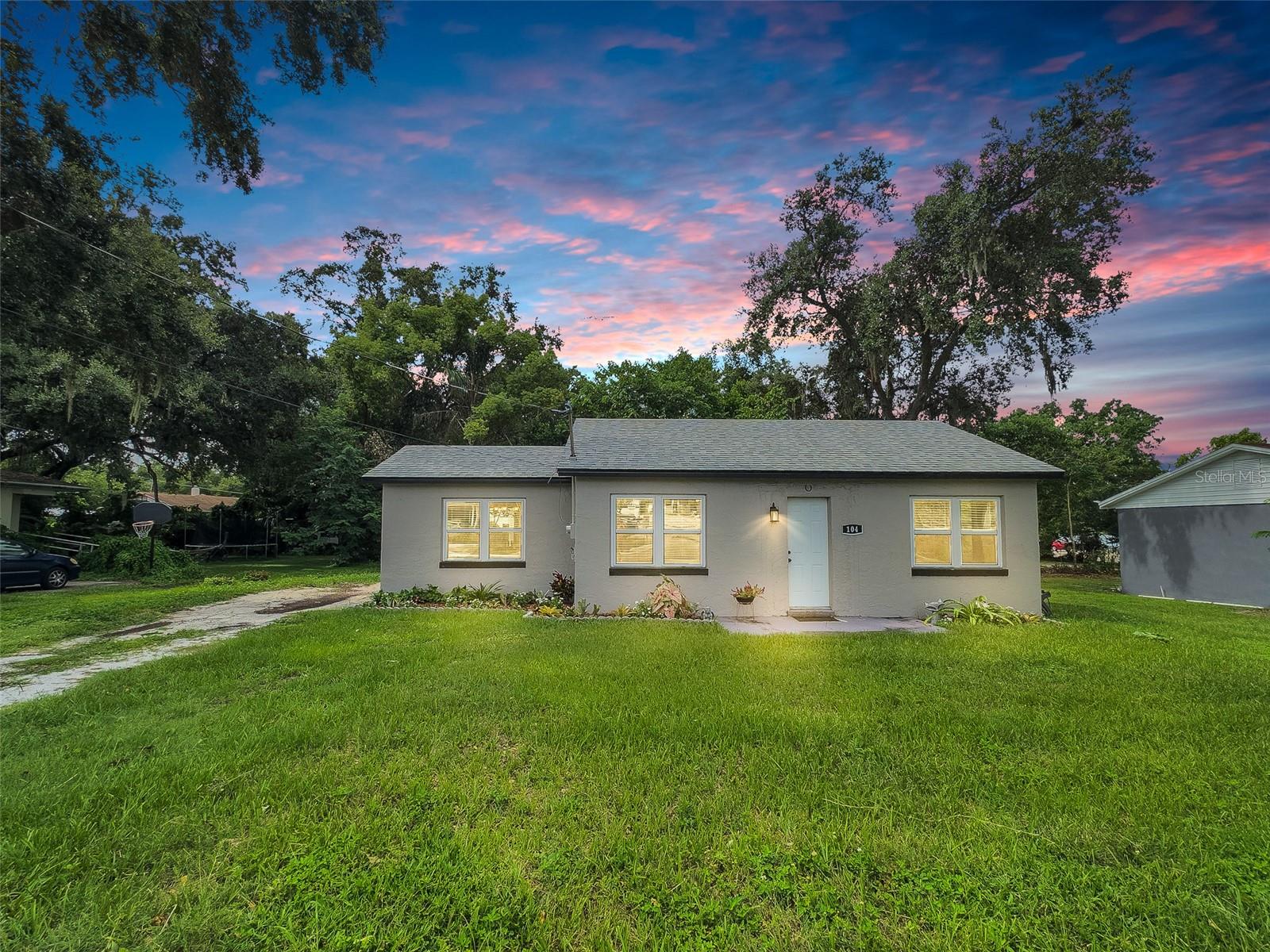 Welcome to 104 Avenue K NE in Winter Haven—a charming, move-in ready 3-bedroom, 1-bath concrete block home offering 1,191+- square feet of tastefully updated living space, including a sunny bonus Florida room and a private, fully fenced backyard. With thoughtful renovations completed in recent years, this home is ideal for first-time buyers, investors, or anyone looking to downsize without compromising on style or convenience. (Click on Virtual Tour to take your digital private tour 24/7)
Step inside to find a bright and welcoming layout, enhanced by fresh interior paint, luxury vinyl plank flooring throughout, and an abundance of natural light. The spacious living room opens to a formal dining area, making it ideal for entertaining. The kitchen has been beautifully updated with granite countertops, crisp white cabinetry, open shelving, a striking deep teal subway tile backsplash, and stainless steel appliances—all included. The refrigerator, washer, and dryer were replaced in 2023, offering peace of mind and modern efficiency.
Each of the three bedrooms is equipped with ceiling fans and windows that invite in natural light. The bathroom has been renovated to include updated tile, a modern vanity, and stylish finishes. Toward the back of the home, you’ll find an inviting Florida room surrounded by large windows—perfect as a home office, library, art studio, or flex space.
Significant upgrades have already been completed, including a new roof in 2023, updated electrical wiring and panel in 2023, new PVC plumbing in 2025, and a brand-new Rheem tankless water heater installed in 2025. The exterior features a private, fenced-in backyard with a shaded sitting area and paver patio, mature landscaping, and a detached block shed currently housing the laundry setup and additional storage. The property sits on a generously sized lot with no HOA, giving you the freedom to bring your boat, RV, or utility trailer without restriction.
Situated on a street that has been recently resurfaced (2024), this home offers easy access to Winter Haven Hospital, Downtown Winter Haven, Polk State College, more medical centers, parks, public lakes (just across the street), walking trails, and local shops. It is also close to the police station and public transportation, making it convenient for commuters.
If you’ve been searching for an affordable, updated home with major systems already replaced, in a central location with no HOA, this is your opportunity. Schedule your private tour today and see why 104 Avenue K NE should be your next address.