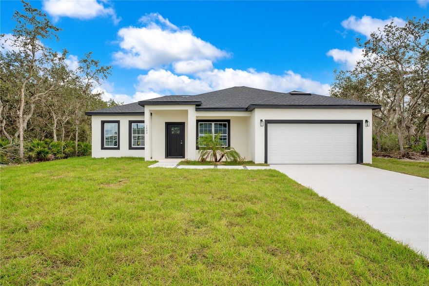 This new construction single-story residence offers the perfect blend of modern design and comfort. With 4 bedrooms, 2 bathrooms, and an open floor plan, this house is ready to become your perfect Florida home. As you step through the front door, you're greeted by an abundance of natural light, large tile flooring throughout, and an expansive formal dining area to your right. The kitchen features stainless steel appliances, an island, light cabinets, and quartz countertops. The kitchen seamlessly flows into the main family area, creating a perfect space for entertaining. Sliding doors lead from the family area to the covered patio and the spacious tree-lined private backyard, providing an ideal setting for outdoor gatherings or peaceful relaxation. The primary suite is a retreat in itself, boasting double vanities, a glass shower, and a generously sized closet. Three additional bedrooms and a bathroom complete the layout, all conveniently situated on the same floor for ease of living. The 2-car garage adds practicality to this home. Centrally located in the Poinciana Villages community, this residence offers easy access to a wealth of amenities, all with the benefit of low HOA fees. Explore nearby attractions such as Poinciana Community Park, shopping centers, restaurants, schools, and a medical center, making every aspect of daily life convenient. Don't miss the opportunity to make this house your home. Schedule a showing today!