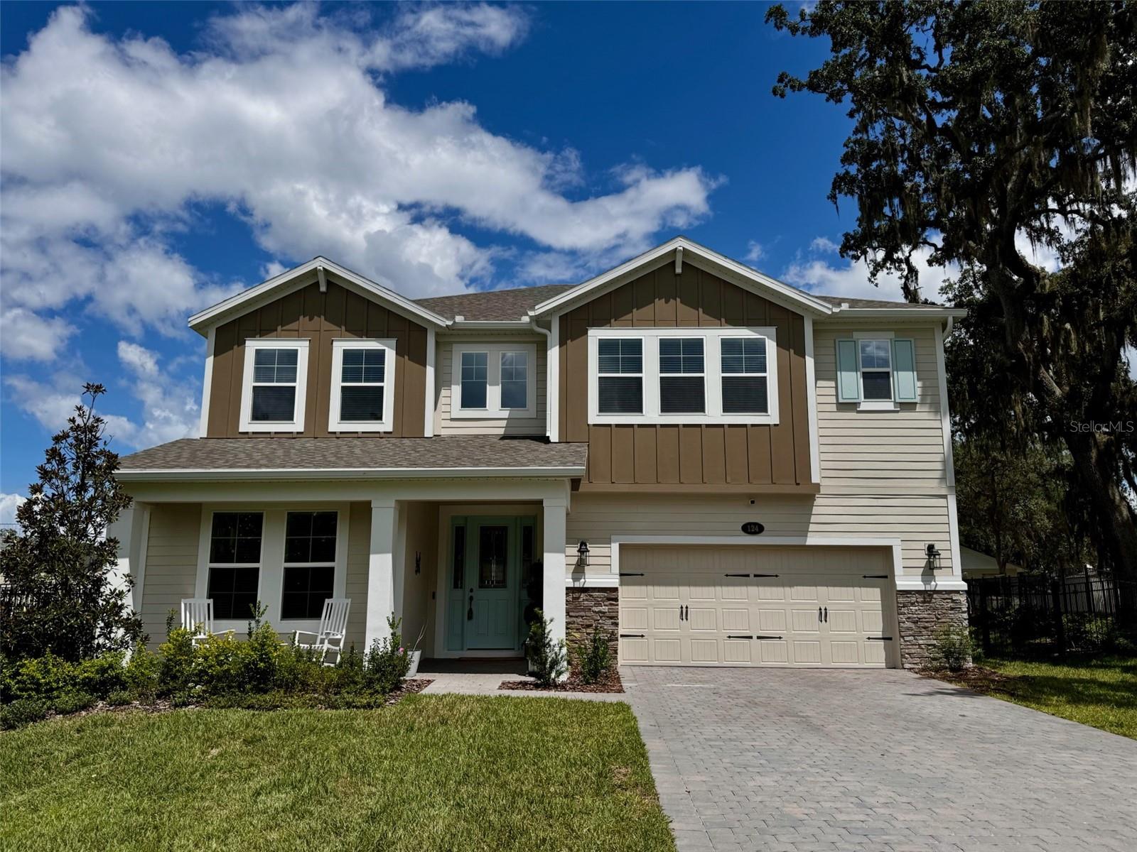 Welcome to 124 Lake Drive, a stunning two-story residence in the heart of Oviedo. Built by M/I Homes, this GreenStar certified energy efficient Glenwood model offers 3,932 square feet of thoughtfully designed living space, featuring 5 spacious bedrooms, 4 full bathrooms, and a 3-car tandem garage. Ideally located just 6 minutes from Oviedo on the Park and 7 minutes from UCF, this home combines modern comfort with convenience. Step inside to an open-concept first floor showcasing a formal dining room, spacious family room, and a bright nook overlooking the lanai. The chef’s kitchen is the centerpiece of the home, featuring a large quartz island, a butler's pantry, an expansive walk-in pantry, and panoramic views of the living and outdoor spaces. A first-floor bedroom with an adjacent full bath, perfect as a guest suite or pool bath, adds to the home’s functionality. Upstairs, double doors open to the oversized owner’s suite, bathed in natural light through large windows. The suite includes an enormous walk-in closet with custom built-ins and a spa-like bath. Three additional bedrooms, (two with large walk-in closets, one with an en suite bathroom)and a spacious loft provide plenty of room for family and guests. Outside, enjoy the nice evening breezes from the lake across the street and the fully fenced yard with plenty of room to add a pool or patio behind the home. The top A-rated Seminole County schools this home is zoned for truly can't be beat! Home is backed by M/I Homes' transferrable 10 year structural warranty. Priced to sell, this home won't last long. Schedule your showing today and make this recently constructed home yours!