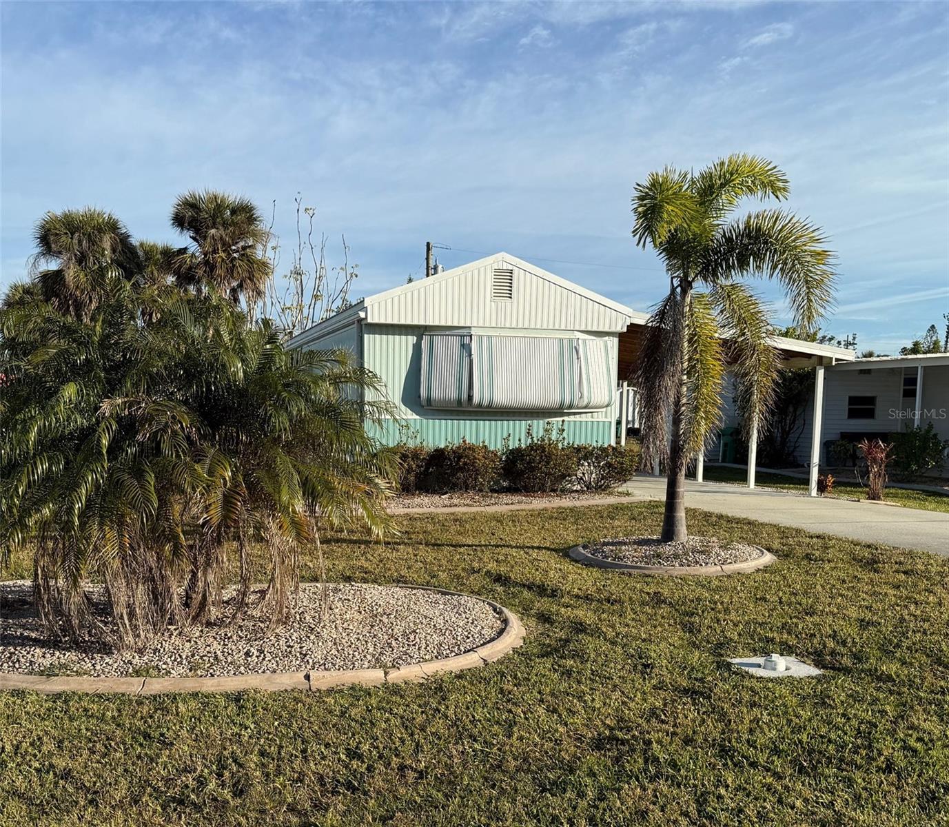 Wonderful location within the Pine Lake neighborhood for this mobile home with great curb appeal. Home damaged in Hurrican Milton and being sold "As-Is". Metal Roof. Newer Carport. No HOA or Deed Restrictions to hold you back. Love Salt Life?? This home is steps away from the canal where boat slips are often available to rent or purchase providing quick access to the intercoastal and Gulf with NO bridges! Beautiful flats nearby to explore with kayaks. This is a terrific opportunity to own an affordable piece of Florida a short distance from the picturesque beaches of both Manasota Key and Boca Grande. Golf Courses, Restaurants, Farmers Markets and shopping nearby to enjoy. Bring all your toys, the possibilities to use them are endless!