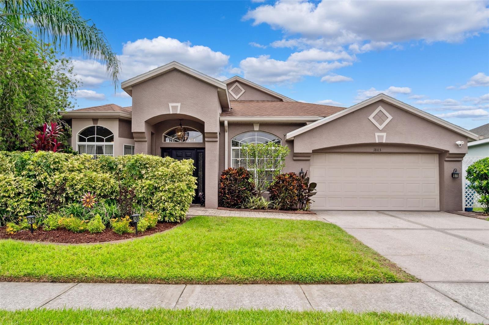 Welcome to this charming 3 bedroom, 2 bath home with a sparkling pool, dining room, 2 bonus rooms, and a 2 car garage nestled in the sought after Meadow Pointe community, conveniently located in the heart of Wesley Chapel. From the moment you arrive, you’ll notice the lush landscaping and fresh curb appeal. Step inside through the front entry into a welcoming foyer that connects to three versatile rooms. The smaller front room boasts a bright bay window overlooking the yard, perfect for a home office, craft room, or cozy reading nook. The second bonus space could be used as a hobby room, playroom, or guest space. Across the hall, French doors lead to the formal dining room with a mirrored accent wall and front yard views ideal for entertaining or even a second home office. The spacious kitchen features a double oven range, plenty of cabinet storage, and space for a breakfast table (if desired)! Bar seating opens directly into the main living area, making it perfect for gatherings. Double sliding doors lead to your private screened in pool, complete with solar heating and a relaxing spillover waterfall. The backyard, freshly landscaped offers colorful blooms and a charming seating area just outside the lanai. The backyard oasis is truly private with just one backyard neighbor. The primary suite includes an updated bathroom with dual sinks, a glass enclosed shower, and a spa style soaking tub. The guest bath, conveniently located off the pool area, makes outdoor entertaining a breeze. Hardwood floors run through the bedrooms, while tile flows throughout the main living areas. Located just minutes from top rated schools, shopping, dining, and with easy access to SR 56 and Bruce B. Downs, you’ll be only 20 miles north of downtown Tampa. This home is truly move-in ready and designed for both comfort and versatility! schedule your showing today!