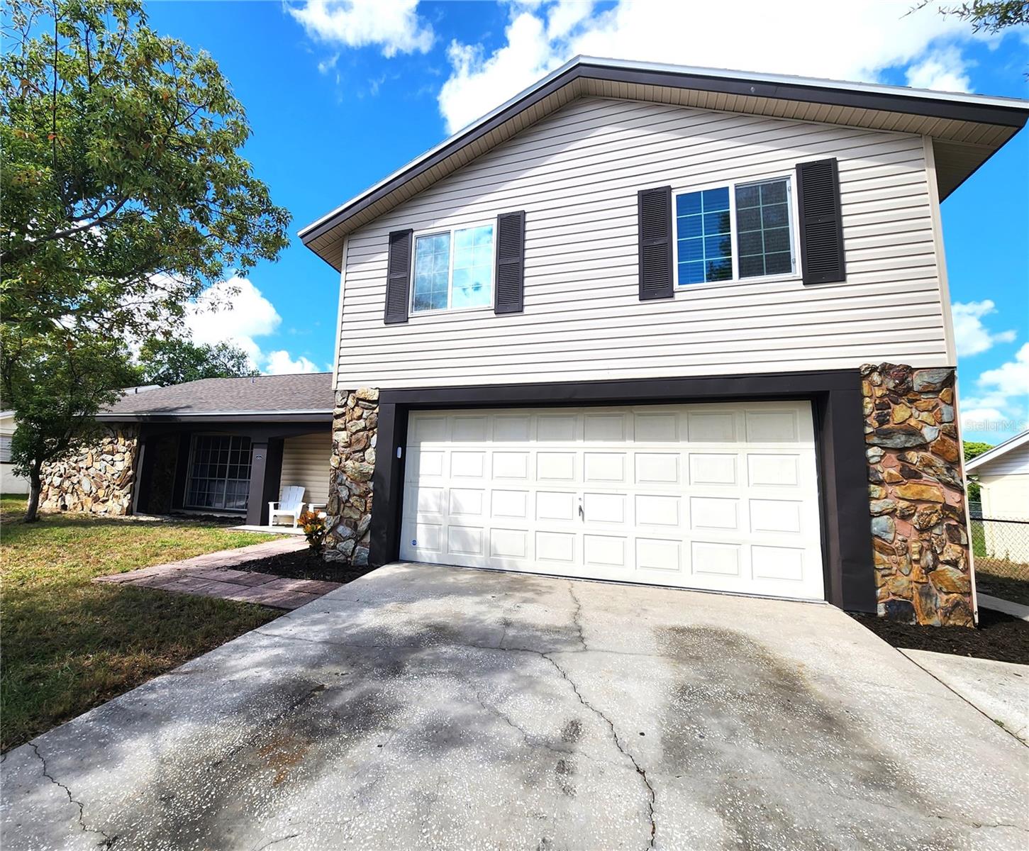 Price Improvement!! Move IN Ready!! Beautiful two story 4 bedroom 3 bathroom home in Beacon Woods Village. As you enter this Gorgeously renovated home you will be greeted by a desirable split floor plan that maximizes both privacy and functionality. As you continue through the home, you will discover the renovated kitchen with granite counter tops, new stainless steel appliances and a pantry for your storage needs. The cozy dining room features a wood burning fireplace, setting the ambiance. The very large living room is a great place for entertaining or you can exit through your sliding glass doors and enjoy your outdoor patio that has a counter and serving window. The primary bedroom retreat features its own en-suite and sliding glass doors where you have the privacy of your outdoor patio. As you walk up the stairs to the second floor you will see two more bedrooms and a bathroom. This home boost several closets for plenty of storage space. The hallway features a very large closet which can be converted into an indoor laundry room. New hot water heater, new roof 2023, new AC 2023, and a fully fenced in yard. The community has low HOA fees, outdoor recreation, and nearby golf course. This property is close to shopping, restaurants, medical, and outdoor activities.