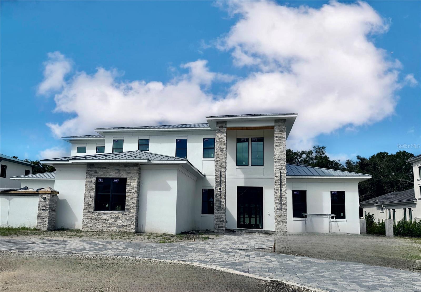 Under Construction. New Construction in Avila! Welcome to this stunning custom-designed home in Avila, Tampa Bay’s premier golf and country club community. Built by BNCH, INC., one of Avila's premier custom home builders, this estate offers an exceptional opportunity for the discerning buyer. Nestled on Orbita de Avila, the final street in Avila to be developed, this residence showcases the finest luxury finishes and amenities. From the moment you arrive, you will notice the striking 12-foot custom front doors welcoming you into an expansive open floor plan. Featuring 5,334 sq. ft. the home features 5 bedrooms, 5 bathrooms, a game room, wine room, home theater, a 4-car garage, and a luxurious swimming pool with spa. Every detail of this home is built to modern codes and the highest architectural standards and is planning to be completed by the end of 2024. Custom doors, wide plank wood floors, intricate millwork, and designer lighting combine to create a truly spectacular home. The gourmet kitchen, a chef’s dream, is equipped with top-of-the-line Viking stainless steel appliances, a gas range, custom cabinetry, and quartz countertops. The kitchen flows seamlessly into the family room, highlighted by a wood-beamed ceiling, wet bar, and linear fireplace, offering the perfect setting for entertaining. The first floor includes a luxurious primary suite with a custom-designed walk-in closet, his-and-her vanities, a separate water closet, soaking tub, and a spacious glass-enclosed shower. Additionally, an ensuite guest bedroom on the main floor provides ideal accommodations for family or guests. Upstairs, you’ll find three more ensuite bedrooms, a home theater, and a game room complete with a beverage center, ensuring everyone in the family has their own private retreat. A private backyard oasis features an outdoor kitchen, swimming pool and spa, a spacious pool deck and fully fenced backyard with beautiful landscaping. Additional features include hurricane impact windows and doors, a metal roof, a generator, tankless hot water heaters and carrier air conditioners. This spectacular estate combines elegance, modern amenities, and the best of Avila living, making it the perfect home for those seeking both luxury and comfort.