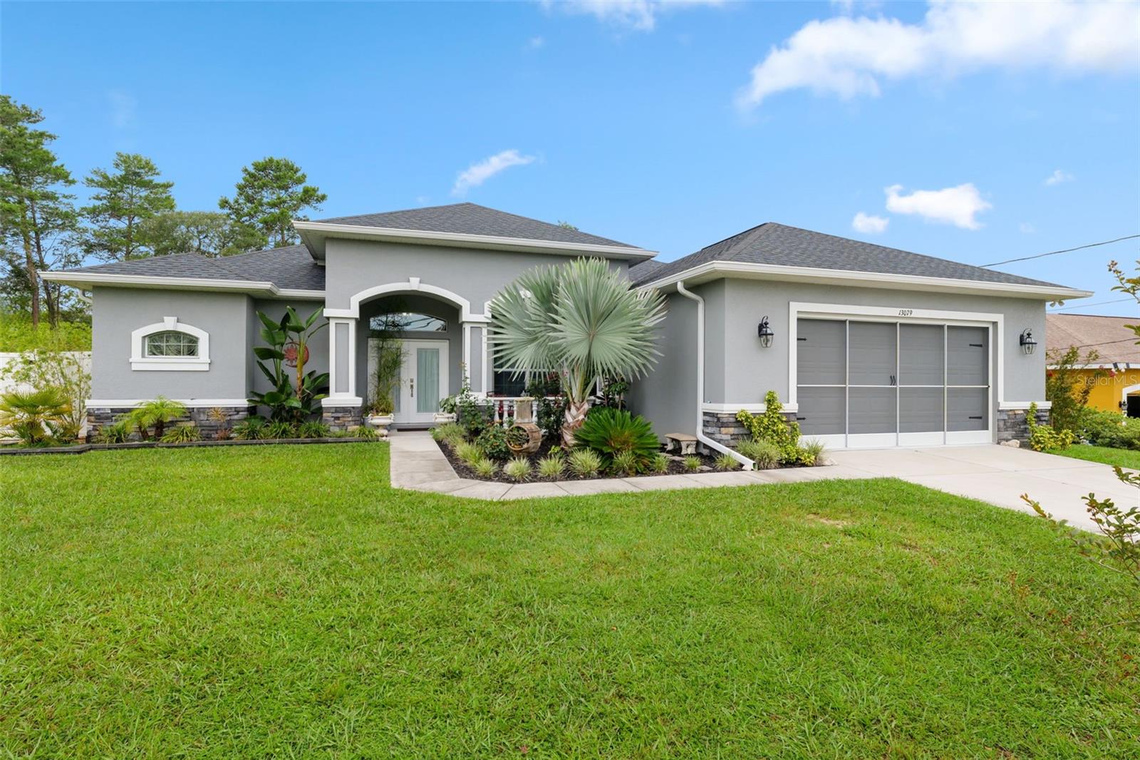 Located in Royal Highlands, this stunning 4-bedroom, 2-bathroom, POOL home, built in 2020, offers the perfect blend of space, comfort, and style. With over 2,200 square feet of living space, a bright open floor plan, and high ceilings throughout, the home feels spacious and welcoming. Tile flooring flows through the main areas, and the split bedroom layout provides both functionality and privacy.
The living room, dining area, and kitchen all flow together, creating an open and connected main living space. The kitchen is well-designed with a large center island, ample cabinet storage, a walk-in pantry, and easy access to the breakfast nook, which features large windows overlooking the pool.
The primary suite is privately situated on one side of the home and includes a spacious en suite bathroom with an oversized shower and double vanity. An added enclosed porch (20x12) provides extra living space, complete with big windows and beautiful views of the pool area. This room also has direct access to one of the bathrooms, making it perfect for guests coming in from the pool.
Out back, the screen-enclosed pool area is finished with travertine pavers and offers plenty of space for outdoor dining, relaxing, and entertaining. The fully fenced yard sits on almost half an acre and includes two storage sheds, fruit trees, and well-maintained landscaping. A two-car garage adds convenience, and best of all—there are no HOA or CDD fees.
This turnkey, move-in ready home is spacious, bright, and thoughtfully laid out—ready for you to make it your own and enjoy Florida living at its best.