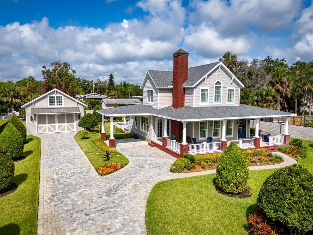 Casual Elegance Meets Refined Coastal Living This exceptional custom residence in Ormond Beach is a rare blend of timeless design and modern craftsmanship—an oasis of coastal casual style that feels lifted from the pages of Southern Living. Every detail has been thoughtfully curated for both comfort and sophistication. Step inside to discover wide plank 8'' premium tile floors throughout, 5 ½'' baseboards, 5'' custom crown molding, and 4 ½'' plantation shutters that frame each room in timeless beauty. A soaring cathedral ceiling in the Great Room, peaked ceilings on the second floor, and tongue and groove woodwork add architectural interest and coastal flair. The gourmet kitchen is a chef's dream, featuring Viking appliances—including a 6-burner gas range, oven, microwave, and dishwasher—paired with a Sub-Zero refrigerator, a stunning 9- foot custom marble island, and elegant white and contrasting gray island custom cabinetry
with a matching range hood. A farmhouse porcelain sink and breathtaking oversized lantern
lighting complete the space.
The Great Room is anchored by a statement wood-burning or gas fireplace, featuring a bold
blood-red brick chimney with a custom copper topper a perfect blend of rustic charm and
luxury.
Retreat to the owner's suite, where a spa-inspired bath awaits with a large soaking tub,
custom filler, marble floors, and a wide entry for accessibility. Dual marble vanities with
custom sinks and hardware complete the space, while every secondary bath showcases
frameless glass showers and premium fixtures throughout.
Upstairs, 7-foot, 5-panel solid-core doors and premium carpet in bedrooms and closets
continue the theme of quality, while the garage apartment offers a private sanctuary of its
own: 513 sq ft of living space with full-size washer/dryer, mini refrigerator, plumbed for a
cooktop/range, large kitchen counters, and an open floor plan with 8" plank tile floors.
The exterior is built to last with HardieBoard siding, double-paned, high-wind-rated windows,
lifetime concrete privacy fencing, custom landscaping, and a 9-zone irrigation system. The 30
x 15 pool with premium equipment is the perfect outdoor retreat, surrounded by pavered
decking and a maintenance-free front porch by Azek, complete with tongue and groove
ceilings and crown molding.
Additional features include:
· Generac whole-house generator for the main residence and apartment
· Buried 250-gallon propane tank
· Gas tankless hot water heater
· Two Carrier AC units for the main home, one for the garage apartment
· Detached garage for 4 cars with 9 X 15 ft doors, 10 ft ceiling, pedestrian entrance, and
access to the apartment above
Situated on a rare double lot (120' x 206'), this property offers just over half an acre of private,
manicured grounds in the heart of historic downtown Ormond Beach. Stroll to local shops,
restaurants, the scenic Intracoastal Waterway, and the beloved Granada Bridge parks. Enjoy
beachside living just 5 minutes away at Ormond's beach ramps or explore Tomoka State Park
just a short drive north.
This home is a masterpiece of casual elegancedesigned for a life well-lived, where luxury
meets comfort in every detail.
Experience a lifestyle of refined comfort in the heart of Ormond Beach.