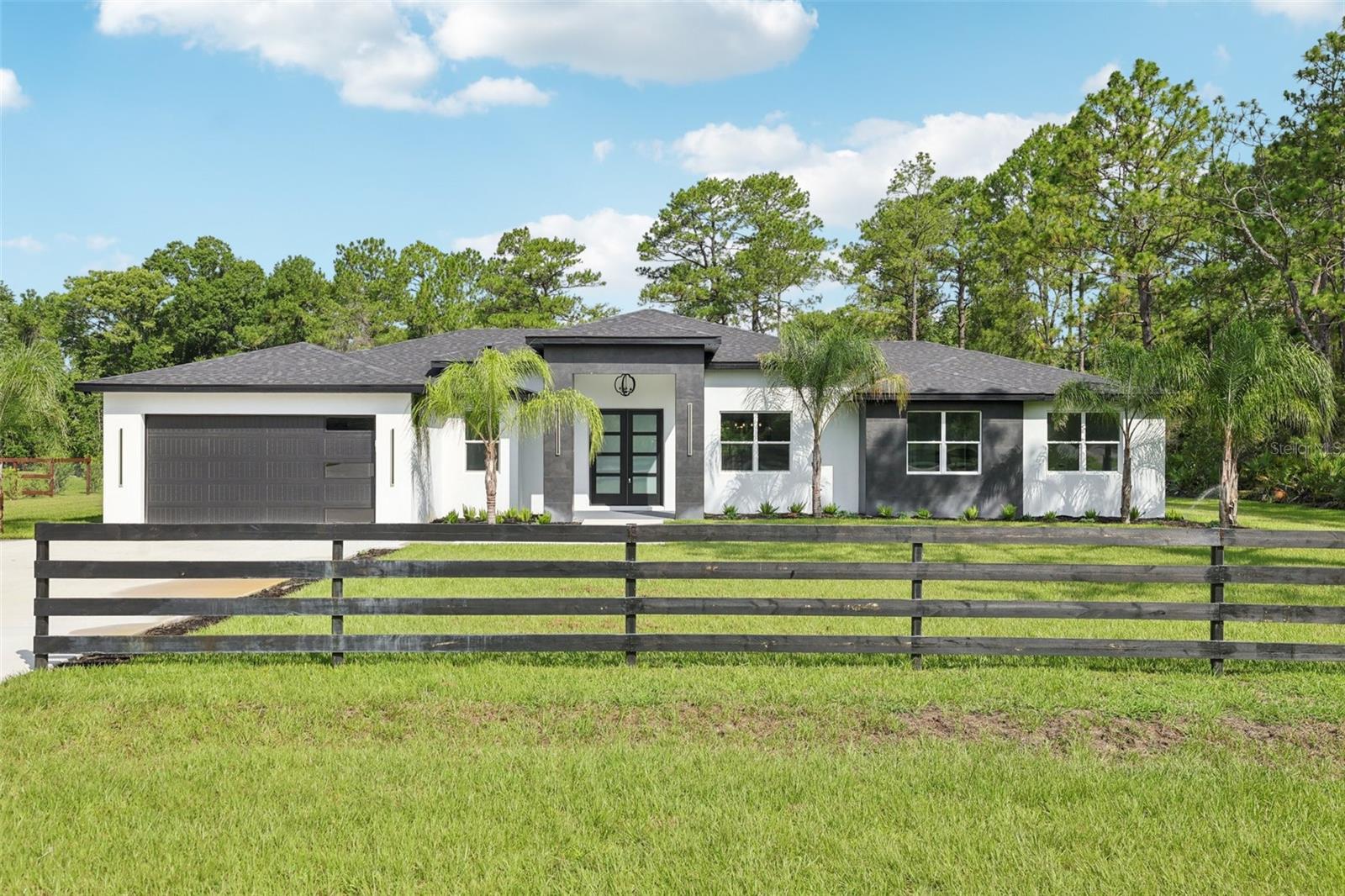 **Just Completed – MOVE-IN READY & Absolutely Stunning!**
This brand-new custom home is finished and waiting for you. With soaring 14' ceilings, luxurious countertops, spacious walk-in closets, and a beautifully designed great room that unites kitchen, dining, living, and media spaces, it’s built to impress from the moment you walk in!
Beautiful built in kitchen counter with sink in the back patio and sitting on 1 ACRE in the desirable Royal Trails community, you’ll enjoy privacy, paved roads, and a rare connection to nature—your backyard ends where Seminole State Forest begins. A 66-foot-wide greenbelt along one side ensures added seclusion, with only one neighbor next door.
This deed-restricted neighborhood has no manufactured homes and HOA is only $80/year. Residents have access to a private boat ramp and dock on 1,200-acre Lake Norris, perfect for outdoor enthusiasts.
Conveniently located near Mount Dora, SR429, Lake Norris Conservation Area, and more.
