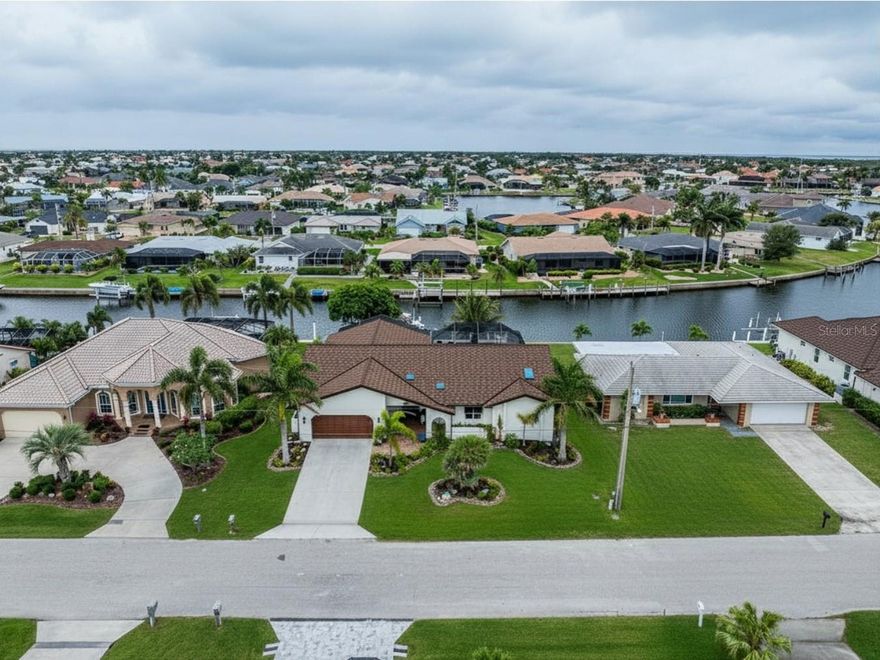 Auction Property. LIST PRICE IS FOR MLS PURPOSES ONLY. ACTUAL PRICE WILL BE DETERMINED AT AUCTION. ONLINE AUCTION ENDS JUNE 11 AT 11 AM ET. This 3BR/3BA Punta Gorda Isles waterfront home provides instant access to a premier social community, Punta Gorda Isles Civic Association (PGICA). Engineered for those requiring a sailboat water home in Punta Gorda with direct Charlotte Harbor access and zero fixed bridges, this residence stands as a benchmark for coastal integrity. Boasting the heavy-duty, superior concrete-block construction standard to 1985 custom homes, it offers a level of resilience that modern builds struggle to replicate, backed by a verified record of zero FEMA claims. Elevation Certification and monthly maintenance costs are available. The residence has 2,258± SF of living area with 3,299± SF total under roof and is situated on a 0.22± acre lot featuring 80± ft. of deep-water canal frontage on a cul-de-sac. Elevated concrete construction topped by a 2025± Tilcor stone-coated steel roof. Hurricane impact rated skylights, windows, and doors throughout. Upgraded with an overhead garage screen, FPL installed surge protection for ultimate grid resilience, and a hidden in-floor safe for secure asset storage. Secure your waterfront asset with an 80± ft. seawall, navigation channels, and a guaranteed 6 foot MLW (Mean Low Water) dockside draft—all fully maintained and insured by the City of Punta Gorda. Enjoy unrestricted, bridge-free access to Charlotte Harbor in just a 10 minute idle, situated directly on an expansive 8± to 15± foot deep turning basin for effortless yacht handling. Premium dockage with a 60± ft. concrete dock featuring a 13,000± lb. boat lift and a dual kayak lift. Illuminated pagoda night docking pillars equipped with 30-amp shore power. Wall-to-wall sliding glass transitions the great room, den, and dining spaces directly to the exterior footprint, complemented by a dedicated pass-through window connecting the kitchen to the outdoor bar. A 16±’ x 32±’ heated gunite pool (refinished in 2024) serves as the focal point, fully protected by an oversized screened lanai with freshly sealed pavers (2025) for a turnkey outdoor experience. A highly sought after triple-split layout offering three private, fully en-suite bedroom wings—perfectly engineered for maximum seasonal occupancy or multi-generational living. The property is positioned for effortless guest arrival and entertainment, located just 45± minutes from Southwest Florida International, 12± minutes from Punta Gorda Airport, within PGICA membership boundaries, and minutes to Fishermen's Village and St. Andrews South Golf Club. Property #: DG26018. Bid Online June 4 - 11. 7% Buyer's Premium. Subject to the final bid at the online auction and auction terms.