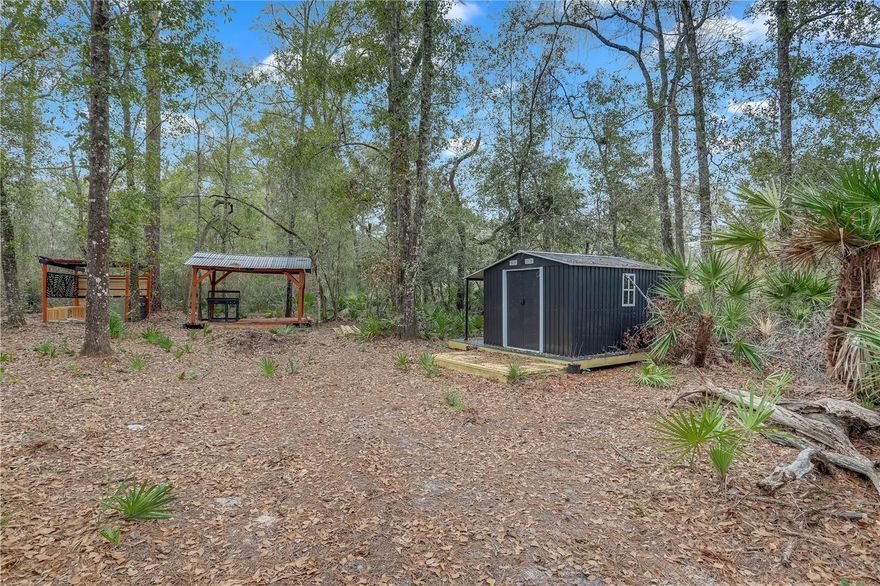 Here's your chance to own a piece of paradise! This lot is over a 1/4 acre, is loaded with extras and is ideally located just a stone’s throw from the Suwannee River and multiple public boat ramps! This is the perfect property for boating, fishing, and enjoying the natural beauty of the area. Fanning Springs State Park is less than 5 minutes from this property and produces 65 million gallons of water daily, making it a second-magnitude spring. Enjoy stunning blue-green spring waters under ancient oaks on the historic Suwannee River! Conveniently situated just off a paved road, the property is already partially cleared and ready for your vision. A new 10.6' x 10.3' building / shed has recently been installed and is just waiting to become your perfect camp cabin. A charming gazebo also offers a head start on creating your outdoor oasis, and a shallow well is in place to support your plans including 2 solar panels, a 200 watt inverter, solar charge controller and plug in for the battery —whether it’s building a getaway cabin or setting up your dream retreat. Don’t let this rare opportunity slip away! Create your dream getaway near the Suwannee River—bring your imagination and make it yours today!