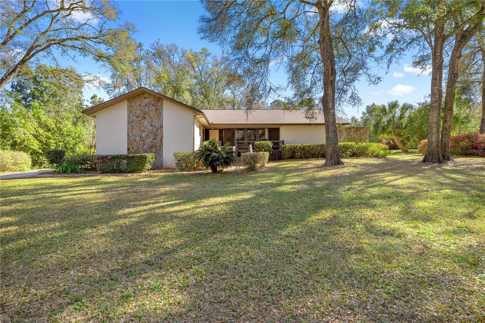 Comfort, Style & Space – 3 Bedroom Home in Rainbow Springs
Welcome to this beautifully updated 3-bedroom, 2.5-bathroom home in the desirable Rainbow Springs community. This property offers comfort, style, and resort-style amenities with access to the Rainbow River, private park, clubhouse, pool, tennis, pickleball, and more.
Inside, you’ll find elegant travertine-style porcelain tile floors, solar panels for energy savings, and a flexible layout featuring two primary suites—ideal for multi-generational living or added privacy. The main suite includes a wheelchair-accessible tiled shower and private porch, while the second suite provides extra space for guests or family. A cozy family room with a wood-burning stone fireplace opens to a 20x20 brick paver patio, perfect for relaxing or entertaining on nearly half an acre of land.