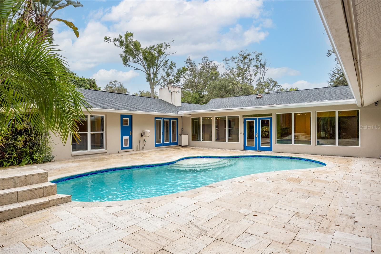 Tucked away on peaceful Hudson Lane, this Carrollwood residence isn’t just a house, it’s a story. Over the years, the owners of 4308 Hudson Lane poured their hearts into creating a place full of memories. Every room, feature, and finish was chosen with purpose, blending craftsmanship with comfort so family and friends could come together and feel at home. Entering the foyer, you'll notice how the natural sunlight fills the home with a warm and inviting feel along with the glass bird cage that the owners had built out for their birds which can easily be converted into a wine cellar. Off the foyer is a separate office space, perfect for anyone that works from home. The chef's kitchen is the heart of the home and is equipped with Thermador and Bosch appliances, granite countertops, two full size refrigerators and an under counter wine refrigerator. You'll find the expansive primary suite on the left side of the home with hardwood floors, a custom walk in closet, and fully remodeled primary bathroom (2024). Off the primary suite is a separate bedroom with a Murphy bed that would make the perfect space for nursery. There is a designated office with built in shelving, perfect for working from home, crafting, or homeschooling. On the other wing of the house are the 2 remaining bedrooms that share a beautifully tiled Jack-and-Jill bathroom. As you step outside the backyard oasis, you'll notice 15,000 gallon, 7ft deep saltwater pool and expansive travertine deck. The pool (resurfaced in 2019) comes with a waterfall, Polaris VRX IQ+ robotic pool cleaner, and custom pet diving pad. The outdoor covered lanai boasts 576 sqft and is loaded with a full outdoor kitchen (gas stove top, double oven, hood, microwave, dishwasher, built in AOG grill, wine fridge, refrigerator), misting cooling fans, heaters, speakers, motorized screens, Werever outdoor cabinets, Vetrazzo countertops, AZEK decking with built in bench. This outdoor area was made for entertainment YEAR ROUND! Relax and unwind on the separate AZEK deck overlooking Sweetwater Creek, where the owners have seen river otters come up for a visit! The landscaping outback is lush and features mango trees, lemon trees, and banana trees providing fresh fruit and privacy in this backyard oasis.
Other notable updates and features include: new roof (2023), main HVAC 211, rear HVAC 2019, garage propane tankless water heater 2018, outdoor propane tankless water heater 2013, hurricane impact windows and doors, Kinetico water softener, R19 spray foam insulation in attic (2018), Gladiator Gearwall panels and shelving in garage, irrigation system, 5 hose reels with hoses, landscape lighting, 2 motorized attic lifts, whole home generator.
This home has been well loved and cared for by its owners but now, it's ready for its next chapter. Schedule your private showing today!
