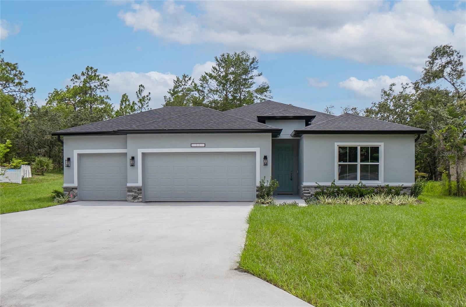 GORGEOUS & BRAND NEW 4 -bedroom, 3-bathroom home located in the beautiful community of Sugarmill Woods. Situated on a greenbelt for added privacy and natural views, this beautifully crafted residence offers 1,990 square feet of living and a spacious 3-car garage. Designed with comfort and functionality in mind, the open floor plan features a gourmet kitchen complete with white wood cabinetry, quartz countertops, stainless steel appliances, an island, breakfast bar, and sizeable pantry—perfect for everyday living and entertaining. Additionally, the interior presents a split floor plan providing privacy, a primary suite offering double walk-in closets and an en-suite bathroom that includes dual sinks and shower, a combination of luxury vinyl plank flooring, tile, and plush carpet enhances the style and durability throughout. The interior laundry room is fully equipped with a washer and dryer. The exterior features a covered lanai and a fully landscaped yard, ideal for enjoying Florida's year-round sunshine. This home is a perfect blend of modern finishes, practical design, and serene surroundings. Topped off with a 2-10 builder home warranty! Conveniently located minutes from shopping, amenities, the Homosassa river, the Gulf of Mexico, and the Suncoast Parkway. Call to schedule your tour!