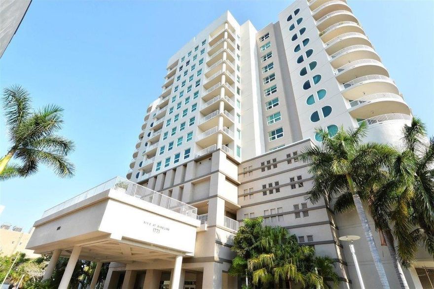 Now available for furnished seasonal rental and/or lease to own.  Experience stunning sunrises from the spacious terrace of this corner unit located in Rivo at Ringling. This distinctive condominium, renowned for its unique style, interior atrium, and upscale amenities, offers a lifestyle of unparalleled sophistication. This 2-bedroom, 2-bathroom, 1,735 sq. ft. residence features a split floor plan with two primary suites, recently renovated bathrooms and brand-new washer/dryer set. The centerpiece of this unit is its central living area, ideal for entertainment. Flooding with natural light the living and dining spaces flow seamlessly onto a large terrace with non-slip tiles. A chef’s kitchen featuring raised panel wood cabinetry, black granite countertops, stainless-steel appliances and plenty of storage has been recently refreshed with contemporary finishes. Relax in your peaceful primary suite with a walk-in closet and renovated bathroom with dual vanities, walk-in shower, and soaking tub. The cozy second bedroom suite boasts a bright and airy atmosphere, complete with a den/study for added functionality and comfort. As a bonus, the large entryway closet has custom built-ins for added storage. This unit also includes two deeded parking spaces and a large storage unit measuring 13’ x 8’ x 10’. Rivo at Ringling offers many great amenities including concierge, heated pool and spa, sundeck with outdoor grill, spacious fitness center, social and conference room for resident's use and a convenient area for bike and kayak storage. A fantastic location within the heart of downtown Sarasota with effortless access to shopping, entertainment, movies, Saturday Farmers Market, airport, and the wonderful beaches of Sarasota.