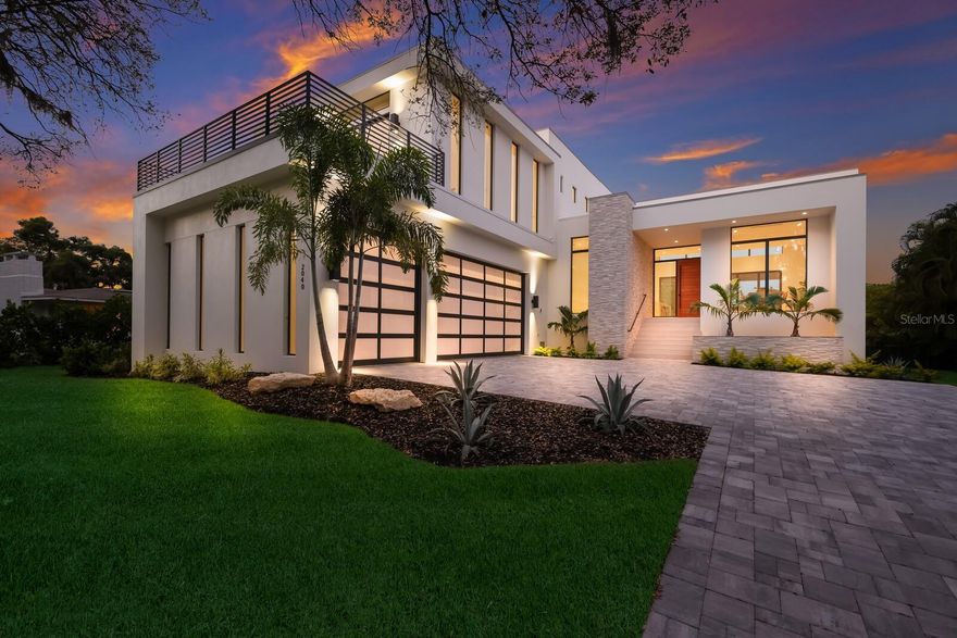 Welcome to Casa Robles. The perfect escape. Take just one step thru the front door and let your eyes wander. This newly built modern home boasting luxurious indoor-outdoor spaces with bay and city views just ten minutes from the city’s vibrant downtown is truly the perfect escape. Designed and built by one of Sarasota’s most successful collaborators, DSDG and Voigt Brothers Construction, this remarkable 5-bedroom, 5.5-bath canal-front home in Indian Beach/Sapphire Shores is mesmerizing. Infused with natural light, the open floor plan boasts 16-foot ceilings in the main living area. A wall of oversized sliders seamlessly transitions the covered terrace into an extension of living space with a massive outdoor dining and kitchen area overlooking the pool and spa. The thoughtfully curated landscaping, using the canal as the backdrop, encloses the property creating a private backyard sanctuary. The west-facing balcony at the front of the home offers a peek-a-boo view of Sarasota Bay while the rear east-facing third story balcony offers panoramic 280-degree views of the city and water. The main floor features a large kitchen with an island overlooking the great room and dining room. The main floor is also home to the lavish master suite which features floor to ceiling glass that accentuate the canal and outdoor oasis with private access to the terrace. A main floor en suite provides guests privacy to relax and reenergize. On the second level is a flex space featuring a private covered balcony and a dry bar. Three additional suites make up the second level featuring the hall ending house favorite en suite with a private balcony. This stunning property offers direct boat access to the bay and is close to just about everything – about 2.5 miles to downtown’s dining, shopping and world-class arts and culture and less than 5 miles to St Armands Circle and beautiful Lido Beach.