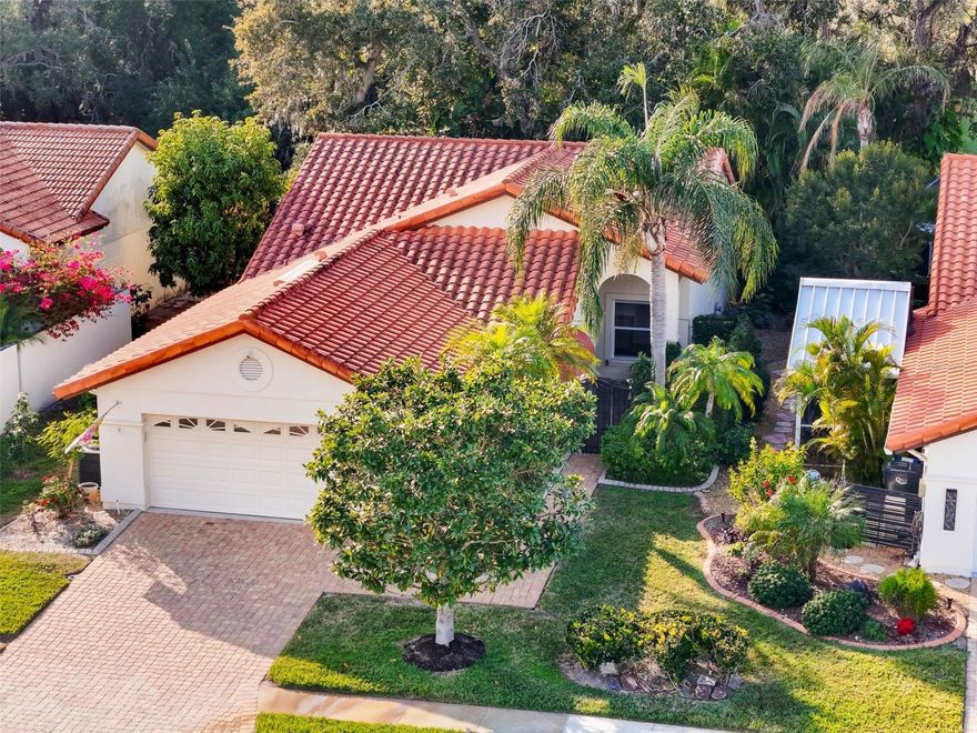 Easy living in this charming free-standing villa home tucked away on a quiet street in Peridia Golf and Country Club, where yard maintenance is included and life feels just a little more relaxed. A paver driveway and walkway lead you through a welcoming courtyard entry, setting the tone from the start.

Inside, high ceilings, abundant natural light, and a comfortable open living and dining area create an inviting space to unwind or entertain. Wood plank tile floors run throughout, adding warmth and durability. The kitchen offers plenty of room with a pantry, island, and cozy breakfast nook, while the nearby wet bar makes hosting easy.

Enjoy Florida living year-round in the sunroom, screened porch, or on the open patio, all overlooking a private, tucked-away backyard that feels like your own secret retreat. The primary suite features access to the sunroom, a walk-in closet, and a spacious bath with dual sinks, soaking tub, and separate shower. A versatile guest bedroom with built-in cabinetry and a Murphy bed offers flexibility for visitors or a home office.

Complete with a two-car garage, indoor utility room, and access to clubhouse activities, golf, and social events, this home is perfectly located between Bradenton and Lakewood Ranch—close to everything, yet peacefully removed. A wonderful opportunity to enjoy comfort, convenience, and an active lifestyle all in one place.