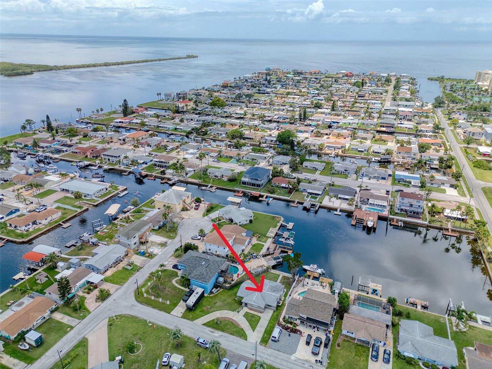 DIRECT GULF ACCESS with BEAUTIFUL LAGOON VIEWS and NO HOA! This 2-3 bedroom, 2 bathroom home is MOVE IN READY with NEW wood cabinets! NEW stainless-steel appliances and NEW quartz countertops with a large counter for entertaining. Sit back and relax in the family room with 2 NEW sliders to enjoy sunsets and water views. The 3rd room has it's own full bathroom so it could be the primary suite, an office or even rent it out because it has it's own side entrance! There is a built in storage closet outside for all your yard or boating equipment and a rear patio for entertaining. NEW interior and exterior paint also! Located on a lagoon with no fixed bridges provides seamless access to the Gulf of America. Spend your days watching dolphins and manatees swim by or cast your line right from your backyard to catch redfish, snook, and snapper. Hudson Beach is a golf cart friendly coastal haven just north of Tampa and Clearwater along the Gulf Coast of Florida. Here, recreational pursuits like fishing, boating and kayaking abound with coastal charm without the crowds. Tiki bar, restaurants, marinas, a public boat ramp and a public beach with gorgeous sunset views are just a 5-minute golf cart ride away. Shopping and hospital are close by on Hwy 19 and just 15 minutes to the expressway for easy access to downtown Tampa and all the airports. Don’t miss this rare opportunity to own an affordable direct Gulf access home and create your own coastal escape!