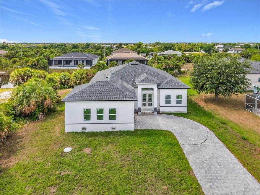 Welcome to your custom waterfront dream home opportunity in the highly desirable South Gulf Cove community of Port Charlotte—where modern design meets the ultimate Florida lifestyle. This thoughtfully designed new construction residence provides over 2,300 sq ft of living space and 3,100 sq ft under roof, blending functionality, elegance, and indoor-outdoor living at its finest. Step through a welcoming foyer into an expansive open-concept great room featuring a spacious family area, formal dining, and a beautifully appointed kitchen—complete with a walk-in pantry and designer wine bar, perfect for entertaining. The split-bedroom layout ensures privacy, with a luxurious primary suite showcasing dual walk-in closets, a spa-inspired bath with separate shower, and two additional bathrooms, one with direct access to outdoor living. There are also two large bedrooms, plus a den with double doors, ideal for a home office, gym, or guest suite. Enjoy seamless indoor-outdoor flow through oversized sliding glass doors leading to a beautiful view of the canal, ideal for relaxing evenings or future pool plans. The  2-car garage measures at 593sq.ft, along with a dedicated laundry room, kitchen pantry and foyer enhance everyday convenience.
Built to current Florida Building Code standards (2023), this home is engineered for durability and peace of mind, including modern energy efficiency and storm resilience. Located in the waterfront community of South Gulf Cove, residents enjoy access to over 55 miles of navigable canals, a public boat ramp, parks, and sidewalks, all with a low optional HOA. Just minutes from the pristine beaches of Boca Grande, world-class fishing, golf courses, and the vibrant dining and shopping of Englewood, Port Charlotte and Wellen Park.
This is more than a home—it’s a lifestyle investment in one of Southwest Florida’s fastest-growing waterfront communities.