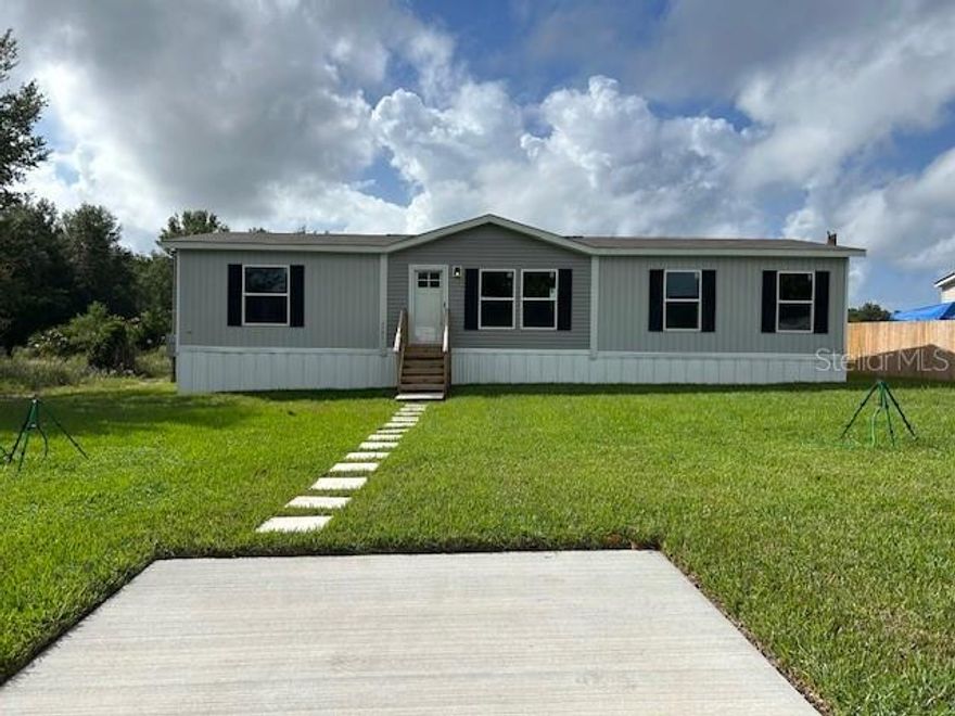One or more photo(s) has been virtually staged. Beautiful new Clayton Explorer home located just minutes from The Villages, shopping, dining, and public lake access to the Harris Chain of Lakes. This modern, energy-efficient design features open living spaces and offers one of the best new-home values in the area.

Unlike many competing homes, this property includes a brand-new well and septic system. The split-bedroom floor plan features a stylish accent wall, coffee bar, and a flexible dining area that can double as a home office.

The kitchen is equipped with 42-inch cabinets, a central island, stainless steel appliances, and a designer range hood. The primary suite includes dual sinks and two separate closets. Recessed LED lighting throughout enhances the modern interior.

Set on a wooded lot with no rear neighbors and just under a quarter acre, this home provides privacy and outdoor appeal. No HOA. Eligible for FHA, VA, and USDA financing. Seller will assist with closing costs. Schedule your showing today!