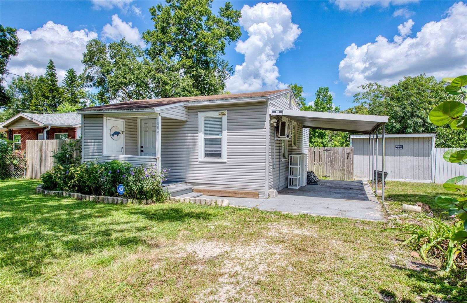 COZY, CUTE, AND CONVENIENTLY LOCATED TAMPA HOME!!! This two bedroom, one bathroom home has so much to boast including a centrical location to USF, Busch Gardens, parks, University Mall, and I-275 just to name a few places that are within about a 10-minute drive. Enter through the front door into the living room area next to an open kitchen. Two bedrooms are in the back of the home and share a bathroom with a walk-in shower in the middle. The current owner has made many renovations and improvements since purchasing in 2022 including installing PORCELAIN TILE FLOORS, ADDING THREE NEW MINI-SPLITS, INSTALLING A NEW MICROWAVE, DISHWASHER, NEW KITCHEN CABINETS, SINK (GRANITE COMPOSITE), PORCELAIN TILE BACKSPLASH, COUNTERTOPS, CABINET FIXTURES, AND WATER HEATER. The spacious fully fenced backyard has two sheds (one 10X12 and one 7X7) for storage and tools along with various fruit trees. Other amazing features include the roof which is approximately 7 years old, the electric panel was replaced in May 2023, and save money with NO HOA, CDD, or flood zone! Make this your new home or investment property!!