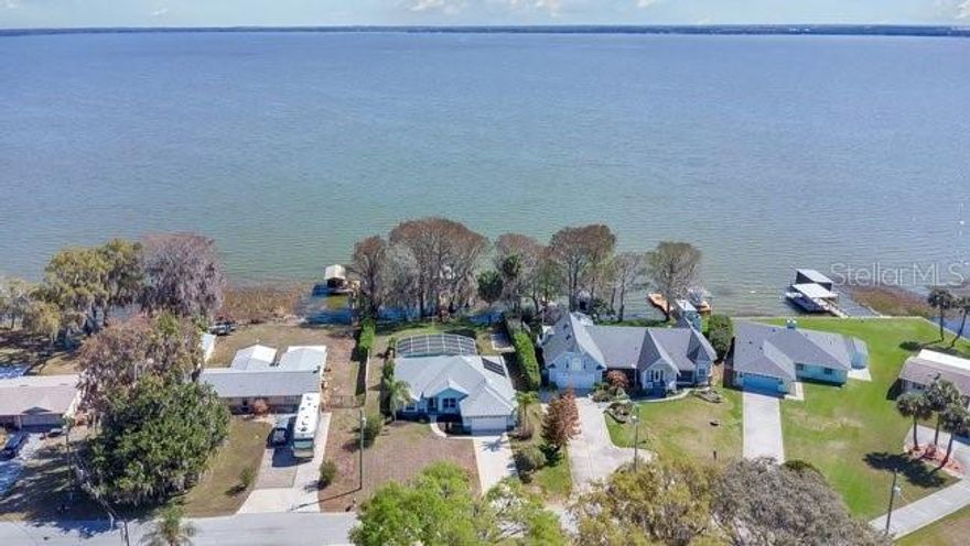 Stunning Lake Eustis Waterfront Home on the Harris Chain of Lakes.  
Experience true Florida lakefront living in this beautifully maintained 3-bed, 2-bath home situated on a large, picturesque lot adorned with majestic cypress trees. Enjoy sweeping views of Lake Eustis from your backyard and direct access to the renowned Harris Chain of Lakes.
This property is built for both relaxation and recreation, featuring a private boathouse with lift—perfect for sunset cruises, fishing, or exploring the interconnected lakes. A solar-heated, screened-in pool offers year-round enjoyment with tranquil water views as your backdrop. Inside, the home boasts a bright, open layout, an oak cabinet kitchen with appliances that are less than a year old. Additional conveniences include an interior central vacuum system and ample storage throughout. With its generous lot size, serene natural setting, and premium waterfront amenities, this home delivers the ideal blend of comfort, beauty, and Florida lifestyle living.   *Kitchen appliances replaced in 2025. Pool pump replaced 2/2026. The dock's wood replaced 2025. Fresh interior paint 2/2026.