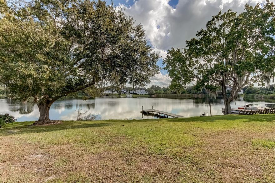 WELCOME TO YOUR CHARMING LAKEFRONT OASIS nestled in the heart of Land O' Lakes, Florida. This spacious 3-bedroom, 2-bathroom ranch home offers an idyllic lifestyle with 100 feet of shoreline on a private 23-acre lake, seamlessly connecting to the picturesque Catfish Lake. Boasting a recently resurfaced dock, embrace the tranquility of waterfront living and the allure of breathtaking sunrises from your own backyard. Upon entering, you'll discover a thoughtfully designed interior featuring a spacious living room/dining room combo, a cozy breakfast room ideal for leisurely mornings, and a large well-appointed kitchen. The large master bedroom looks out over Myrtle Lake and features a full attached master bath with a separate shower and tub. Two smaller bedrooms and a second bath round out the living space. The home is complemented by an oversized garage equipped with a convenient workbench and built-in shelving, catering to hobbyists and DIY enthusiasts alike. A large laundry room adds functionality and convenience to daily routines. For those of you who love to spend more time outside than in, a 20' x 10' screened patio overlooks the spacious backyard, the dock, and the lake. Convenience meets comfort as this residence is strategically located a short distance from Lake Myrtle Elementary, the Land O' Lakes Library, and the Recreational Center, offering endless opportunities for recreation and educational pursuits. Additionally, the esteemed Academy on the Lake is within easy reach. Nearby, find an array of grocery stores and shops just a short distance away, enhancing the ease of daily living. This home has been meticulously cared for, boasting recently repainted interior and exterior, offering a fresh and inviting ambiance for its new owners. Embrace the Florida lifestyle with serene lake views and the convenience of nearby amenities, all while relishing the privacy and tranquility this property affords.