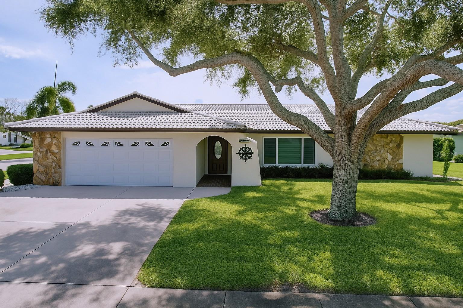 WOW! Lakefront Living and just Minutes from the Beach! Welcome to this spectacular lakefront home in Hillcrest Manor, one of Largo’s most sought-after neighborhoods. Perfectly located just minutes from the white sands of Indian Rocks Beach, this beautifully maintained 3-bedroom, 2-bath, 2-car garage block home sits on an oversized .31-acre corner lot with peaceful lake views from the screened lanai. Best of all, this home is situated in a NON-EVACUATION ZONE and does NOT REQUIRE FLOOD INSURANCE (ZONE X), offering both comfort and peace of mind. From the moment you arrive, you’ll notice the pride of ownership throughout the property. FEATURES INCLUDE: Hurricane IMPACT-rated windows and doors, a 2022 HVAC system, concrete barrel tile roof, an oversized driveway, finished garage floor, inside laundry room with extra storage, and a sprinkler system to keep the yard lush and green. Inside, a bright and inviting split floor plan offers both comfort and privacy. The expansive 22' x 13.5' Primary Suite includes a walk-in closet and a beautifully updated en-suite bath with a walk-in shower, frameless glass doors, and a granite-topped vanity. Two additional guest bedrooms are generously sized and share a modern full bath. The home offers two distinct living spaces — a formal living room filled with natural light and a cozy family room with a wood-burning fireplace and tranquil views of the lake. The fully updated kitchen is truly a chef’s dream, featuring high-end stainless-steel appliances, solid wood cabinetry, granite countertops, a spacious center island, and ample counter space perfect for entertaining, preparing large meals, or simply enjoying your morning coffee while watching the water. The quality craftsmanship extends throughout the home, from solid wood trim and window frames to the tastefully updated guest bathroom. Step out to the screened lanai to relax, unwind, and soak in the beauty of the serene lake view. Hillcrest Manor offers a prime location in unincorporated Largo with quick access to Indian Rocks Beach, a nearby marina, area parks, Largo Golf Course, and a variety of local shops and restaurants. It’s also within walking distance to Oakhurst Elementary, an A-rated public school, and close to other highly sought-after public and private schools. Properties like this rarely become available in such a desirable area — don’t miss your chance to experience the perks of lakefront living. Schedule your private showing today!