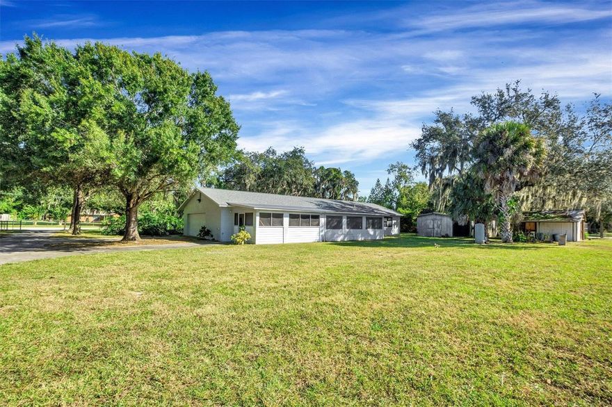 Looking for picturesque country living while still conveniently located in close proximity to restaurants, shopping centers, top attractions, and medical complexes? This beautiful 3-bedroom, 2 bathroom home truly is the best of both worlds! Boasting over an acre of fully fenced land featuring a gated driveway, this property allows for intentional living. Imagine cultivating a backyard harvest, collecting fresh eggs from your own chickens, and having both flexibility and freedom for those outdoor projects with NO HOA to answer to! Transform the 28x36 fully concreted pole barn equipped with electricity into your own personalized workshop. Recent renovations include fresh interior paint in main living spaces, an upgraded kitchen showcasing stainless steel appliances, modern cabinetry with generous storage, as well as a large walk-in pantry. The roof was replaced in 2018, and the home features a spacious fully enclosed Florida room with an additional screened porch to maximize indoor/outdoor living. Nestled on a quiet street, this turn-key home provides privacy without isolation, and nature without sacrificing convenience. Minutes from the renowned Legoland resort and theme park, as well as Circle B Bar Reserve known for its stunning walking trails, and abundant wildlife viewing creating an ideal location. Additionally, the home is a short drive to the iconic Chain of Lakes offering the epitome of Florida living with boating, fishing, paddle-boarding, water skiing, and kayaking galore!