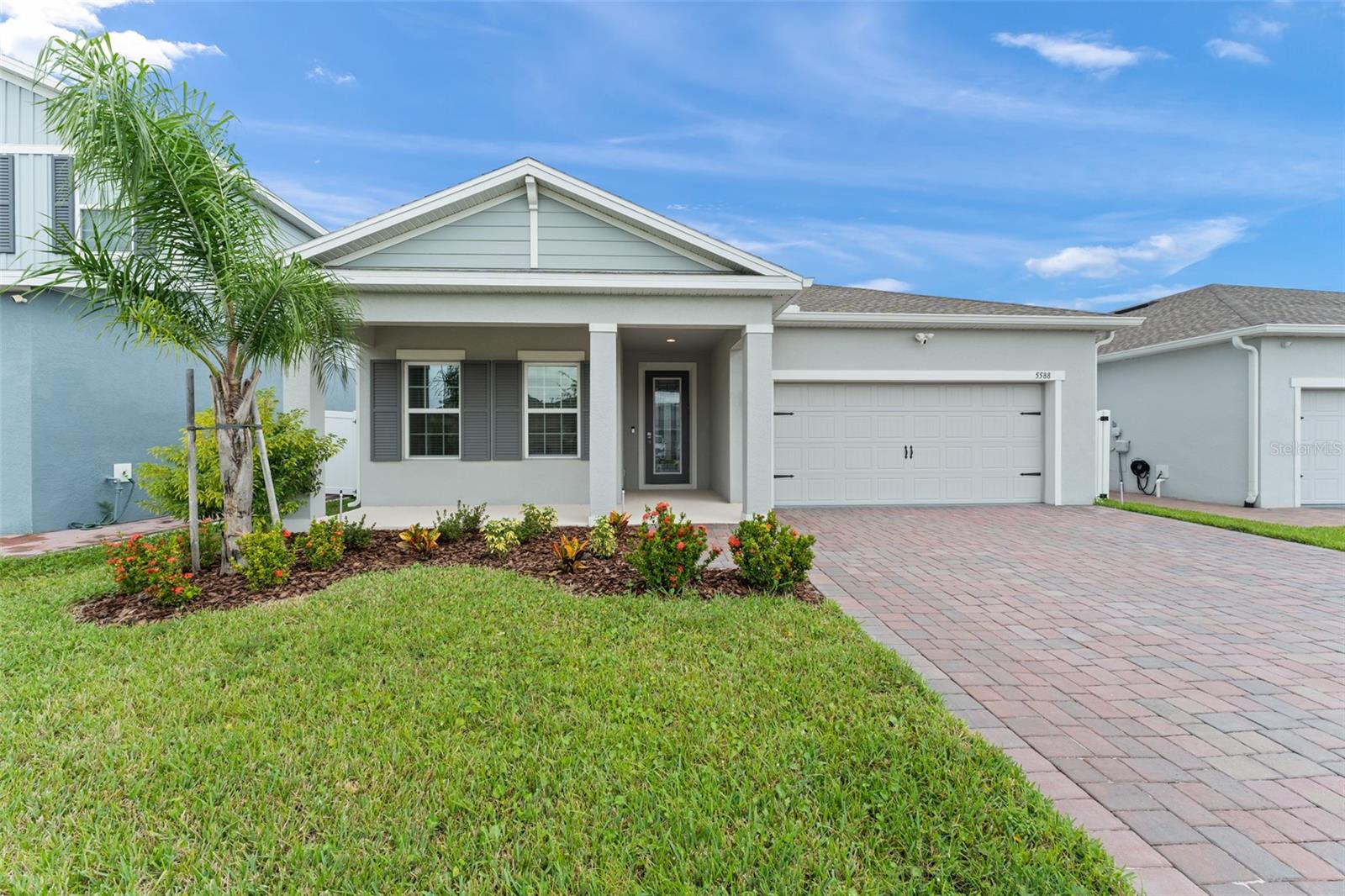 Welcome home to your like-new residence built in 2023 offering the perfect blend of modern convenience, thoughtful upgrades, and spacious outdoor space. With 4 bedrooms, 2 bathrooms, and 2,045 sq. ft. of open living space, this home is immaculate, move-in ready and designed for both comfort and style. One step inside and you'll find a bright, spacious floor plan anchored by a chef’s kitchen with 42” white cabinetry, a large breakfast island for gathering, and stainless steel appliances. The home is equipped with smart features including a Nest thermostat, Wi-Fi enabled garage door opener, and keyless door entry for everyday ease. The primary suite is a true retreat, boasting an oversized walk-in closet and a serene ensuite bath. A covered lanai extends your living space outdoors, overlooking a fully fenced backyard with room to play, relax, or reimagine your outdoor oasis! Here, you’ll also enjoy your own mango, papaya, Barbados cherry, longan, and sapodilla trees...a tropical oasis right at home! Siena Reserve is conveniently located near schools, shopping and major roadways. Schedule your private showing today and make 5588 Vigo Loop your own!
