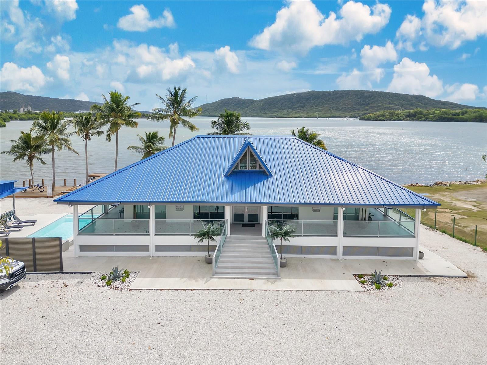 Welcome to this stunning, fully remodeled property in Guánica, ideally located at the entrance of Playa Santa. Formerly known as Restaurante La Vinera, this two-story residence has been completely renovated, from plumbing to electrical systems, and is now a modern, fully furnished retreat. With 6,000 sq. ft. of space on a 2,137 m² lot facing the beautiful BahÃa de Guánica, this home is perfect for a private residence or a Airbnb investment accommodating up to 40 guests. The first floor features four bedrooms, two bathrooms, a spacious kitchen and dining area, a family room, and an indoor mezzanine with 10 beds, along with a pool table for entertainment. The second floor offers four interconnected studio apartments, each with a private bathroom, a shared kitchen, and a game room, also accommodating up to 20 guests. The outdoor area is a true paradise, boasting a private dock, a boat and jet ski ramp, a pool and jacuzzi, an electric vehicle charging station, a 60kW power generator, a 1,000-gallon water cistern, and a gazebo with a fully equipped outdoor kitchen, including a BBQ and freezer. Located in a peaceful and picturesque setting, this property is a rare opportunity to own a luxurious waterfront escape in one of Puerto Rico’s most desirable coastal locations. Coordinates: 17.972723,-66.926323
Don’t miss out—schedule your visit today!