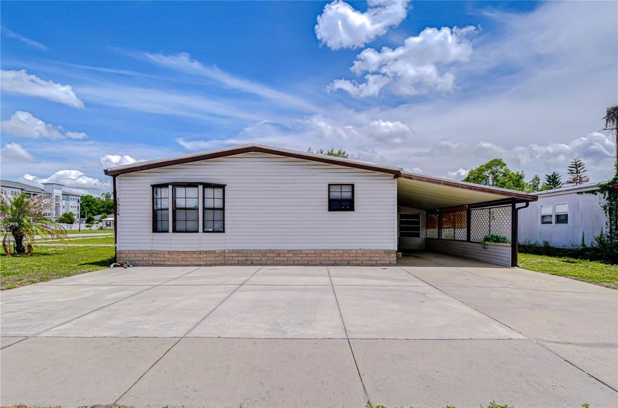 Your Florida Retreat Awaits! If you’ve been searching for a place that offers comfort, convenience, and a relaxed Florida lifestyle, this new listing in Terrace Park is one you won’t want to miss. Situated on a desirable corner lot  across from the community pool, this well-maintained 3-bedroom, 2-bath  home is designed for easy living, whether you’re looking for a seasonal getaway or a full-time residence. From the moment you arrive, you’ll notice the thoughtful features that make this home stand out. There’s ample parking with an extended driveway, a covered carport, and additional space for guests. The inviting front porch creates the perfect setting for morning coffee or unwinding in the evening, while the Florida room offers a bright, versatile space to relax or entertain year-round. Inside, the layout flows comfortably with a formal dining area just off the kitchen and living room, making it ideal for both everyday living and hosting. The spacious living room opens seamlessly into the Florida room, adding even more usable living space. The split floor plan provides privacy, with a generously sized primary suite that easily accommodates a king-size bed and large furnishings. The en-suite bathroom offers plenty of room to  stay organized. On the opposite side of the home, you’ll find two additional bedrooms, both large enough for queen beds with one currently serving as a home office, along with a well-appointed guest bath. Additional features include a storage shed/workshop for hobbies or extra storage, and a home that has been meticulously cared for throughout. Located in a pet-friendly senior community with low fees,  perfectly positioned between Wesley Chapel and Zephyrhills, offering easy access to State Road 54, State Road 56, and US 301 making shopping, dining, and medical facilities all  conveniently close.If you’ve been dreaming about a low-maintenance lifestyle, a winter retreat, or a comfortable place to retire, this home checks all the boxes.