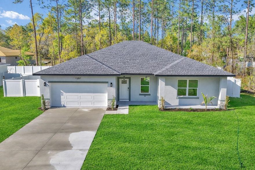 BRAND NEW CONSTRUCTION FULLY FENCED – $2,000 A MONTH! Gorgeous 4-bedroom, 3-bathroom home in Ocala, FL, offering 2,466 sq ft of modern living space. The expansive kitchen boasts a large island, stainless steel appliances, elegant countertops, abundant cabinet space, and a dining area perfect for gatherings. A new washer and dryer will be installed by the owner prior to move-in. Luxury vinyl flooring flows throughout the home, and the main suite features a resort-style bath with a soaking tub, dual sinks, and a walk-in closet. Enjoy a two-car garage, a private deck for relaxing Florida sunsets, and a fully fenced yard for added privacy. Located on a street of beautiful new homes, this property combines seclusion with charm. Conveniently located with a Walmart just 8 minutes away, plus about 1 hour to Orlando and 1 hour 25 minutes to Tampa. Easy to show—schedule your tour today!