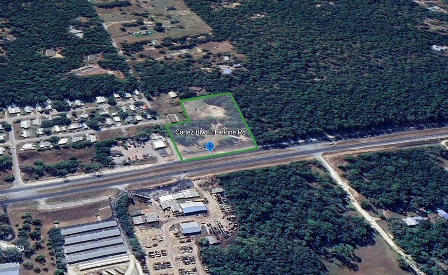 Prime Commercial Opportunity on Cortez Blvd – 2.15± Acres in Growing Brooksville Corridor
Located just west of 29114 Cortez Blvd. in Brooksville, FL, this high-visibility assemblage offers 2.15± acres across two contiguous parcels:
• Parcel Key #01065965: 1.50± acres with direct frontage on Cortez Blvd
• Parcel Key #00386763: 0.65± acres with access from La Pine Rd
Zoning is a mix of C2, R3, and AR, offering flexibility for commercial, residential, or mixed-use development. With strong highway frontage along State Road 50 (Cortez Blvd), the site sits along a major commercial corridor that continues to attract investment and expansion.
Property Highlights:
• High-visibility Cortez Blvd frontage
• Combined 2.15± acres (two parcels)
• Flexible zoning: C2/R3 & R3/AR
• Surveys available upon request
• Dimensions vary – contact for more details
• Suitable for retail, office, medical, or light industrial
Thriving Commercial Environment:
Surrounded by a mix of national and regional businesses, the property is proximate to:
• Walmart Supercenter, Lowe’s, Tractor Supply Co.
• Capital City Bank, SouthState Bank, and Regions Bank
• AutoZone, O’Reilly Auto Parts, and multiple auto dealerships
• Distribution facilities and light industrial parks nearby
• Restaurants including McDonald’s, Wendy’s, Popeyes, Dunkin’, and local diners
• Gas and convenience options such as Circle K, Racetrac, and Mobil
This growing corridor has become a hub for logistics, trade services, and retail activity — ideal for businesses looking to capitalize on the area’s increasing traffic and customer base.
Strategic Location:
Just minutes to the I-75 interchange, with convenient access to:
• Tampa International Airport – approx. 50 minutes
• St. Pete–Clearwater International Airport – approx. 1 hour
• Downtown Brooksville – approx. 20 minutes
• Wesley Chapel/SR-56 corridor – approx. 30 minutes
• Nearby CSX rail lines and Hernando County’s expanding industrial parks
Market Overview:
Brooksville continues to grow as a residential and commercial destination. Its strategic location along the Nature Coast and central Florida logistics routes makes this site a smart investment for future development.