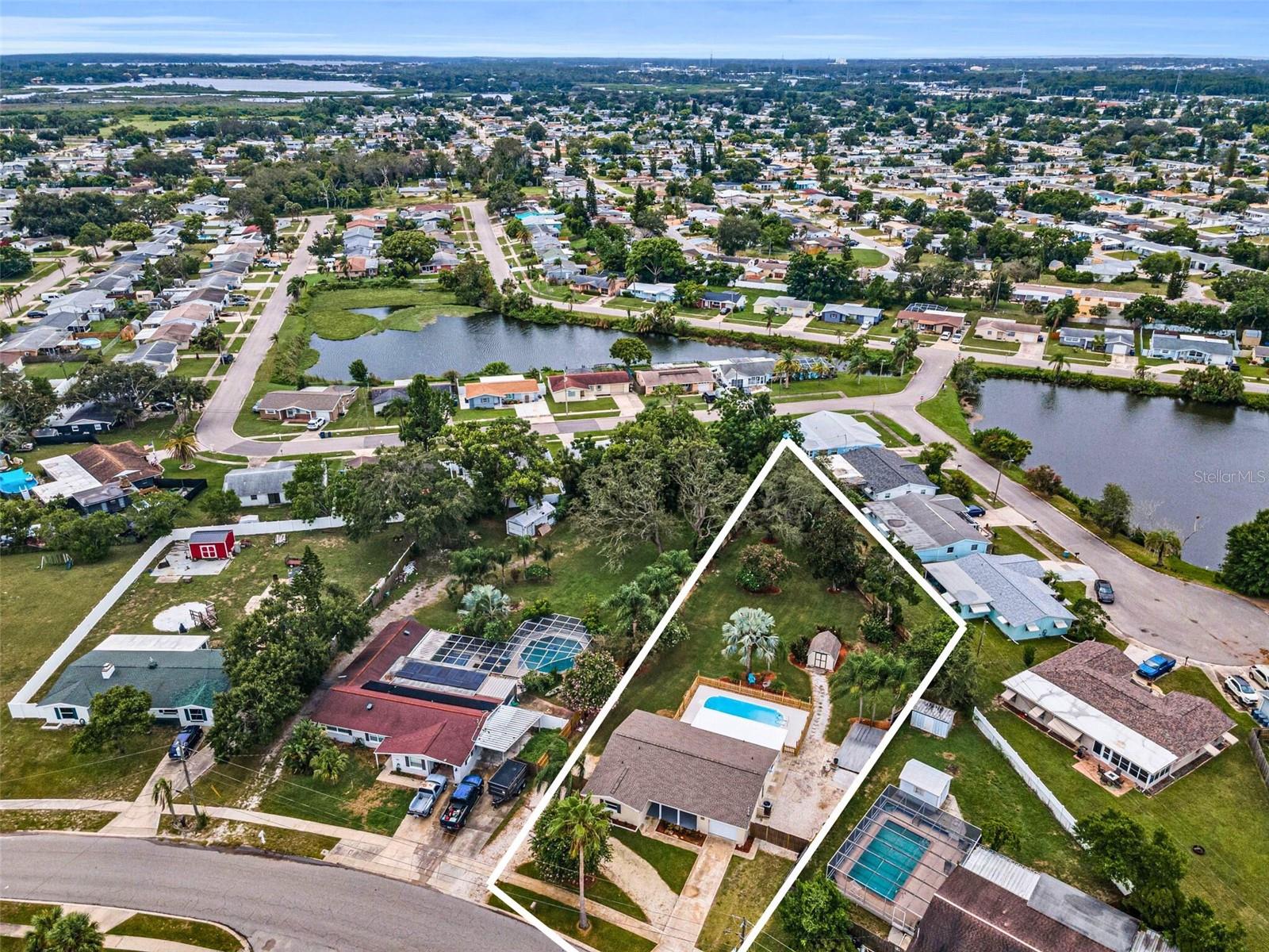 Welcome to 5022 Forest Hills Drive—a rare opportunity to own over half an acre of private, Florida land with no Flood Insurance, no HOA, no CDD, and no rear neighbors. This freshly painted, move-in-ready pool home has been thoughtfully updated with a brand-new roof, new A/C system, stylish new kitchen, many new areas of flooring in the living spaces, the layout is open and airy, perfect for relaxed everyday living or entertaining guests. But it’s the backyard freedom that truly sets this property apart. With a lot this size, you can park your boat, RV, trailers, work trucks or extra vehicles with ease—and still have room to build a detached garage, workshop, garden, or even an accessory dwelling unit (subject to zoning). Whether you're dreaming of a backyard firepit, chicken coop, or just wide-open green space to let the dogs run free, this is your blank canvas to create your own slice of paradise. Located just minutes from the Pinellas County line, you're in the perfect position to enjoy everything the Gulf Coast has to offer—10-15 minutes to white-sand beaches, 10 minutes to the vibrant shops and restaurants of downtown Tarpon Springs, and just 40 minutes to Tampa International Airport for easy travel. This is the kind of space and flexibility that's nearly impossible to find at this price point—don’t miss it!
