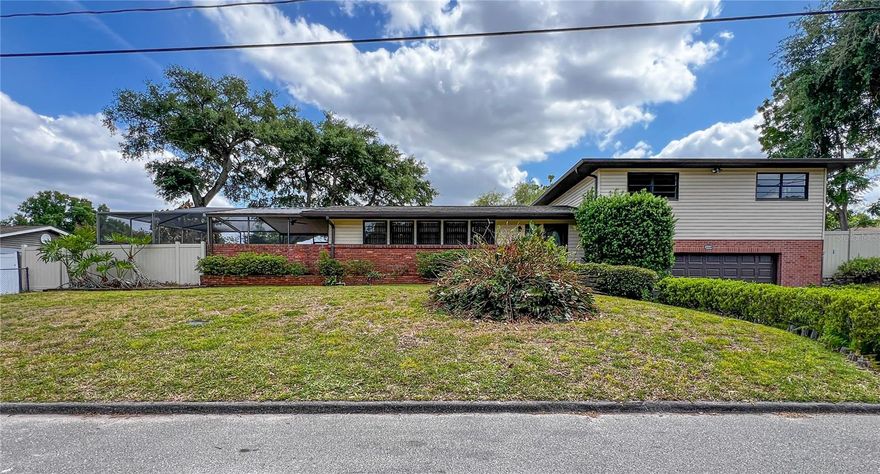 Distinctive mid-century split-level “spool” home set on a spacious 1/3+ acre lot in the sought-after Lowry Park Central area! Showcasing classic mid-century elements, the main living area features expansive windows that fill the space with natural light, creating a bright and inviting atmosphere, and flows into a warm and character-rich family room highlighted by vaulted, wood-beamed ceilings, rich wood paneling, and a charming brick fireplace. The kitchen is well-sized with generous counter space, abundant cabinetry, and a convenient breakfast bar, and opens to a bright dining area with a seamless connection to the surrounding living spaces—ideal for both everyday living and entertaining. A conveniently located main-level half bath adds to the home’s functionality, while key system updates—including a 2020 A/C, 2021 water heater, and recently updated roof sections (2025–2026)—provide added peace of mind.</p><br >Upstairs, the split-level design provides a private bedroom retreat, with three bedrooms and two full bathrooms thoughtfully separated from the main living areas. Hardwood flooring runs throughout the bedrooms, adding warmth and continuity, while a spacious landing with additional closet storage enhances functionality. The primary suite includes its own en-suite bath, and the additional bedrooms offer flexibility for family, guests, or a home office.</p><br >Set on an expansive 1/3+ acre lot, the property offers ample space for outdoor living, entertaining, or future enhancements. The screened-in “spool”—a saltwater spa/pool combination with an electric heater—creates a private, year-round retreat to relax and unwind, with the heater, saltwater generator, and cartridge filter all updated approximately five years ago. A built-in outdoor grill provides the perfect setup for entertaining, while a storage shed and spacious garage offer plenty of additional storage and functionality. Ideally located just minutes from downtown Tampa, major roadways, and nearby parks, this home offers a rare combination of character, space, and convenience. Homes with this much charm and opportunity don’t come along often—schedule your private showing today.