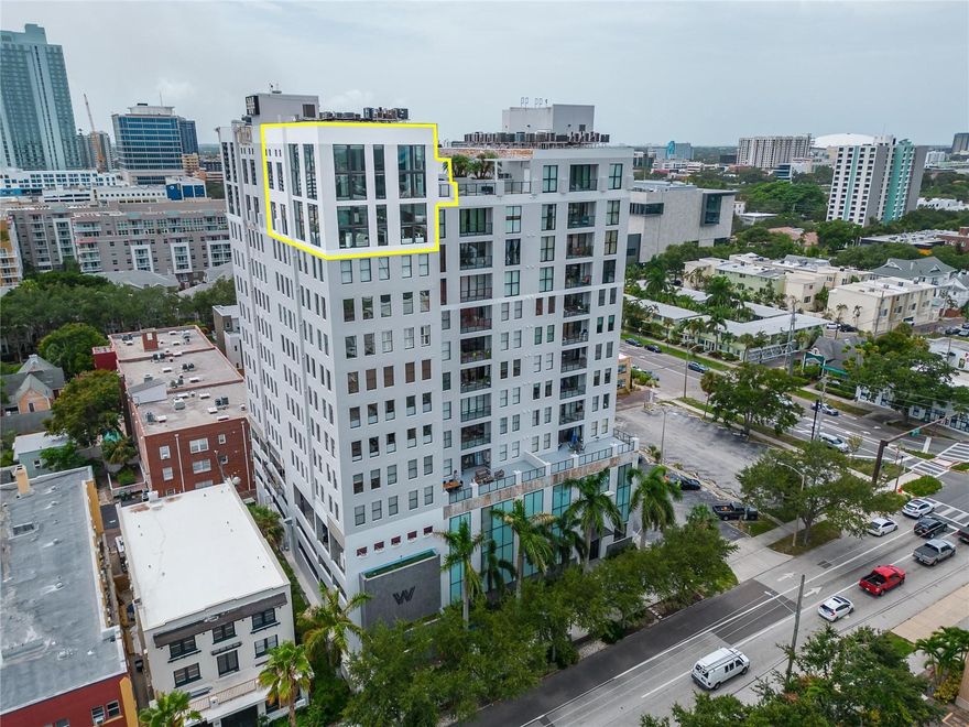 Welcome to the luxurious and contemporary city sleek penthouse located in beautiful downtown St. Petersburg. This gallery-style penthouse offers the best views of all that downtown St. Pete has to offer! With sweeping 180-degree vistas from every floor, this beautiful penthouse is the largest suite in the Walker Whitney Plaza featuring almost 3,000 heated sq ft of elegance and inspiration. Enter into the fashionable and modern main living space with soaring 27 ft ceilings. Floor-to-ceiling windows that allow natural light to flow in, creating a space that is both stunning, bright, and welcoming. Electric shades for privacy when needed. This entertainer's dream home has a culinary-ready kitchen equipped with top-of-the-line appliances such as SubZero refrigerator, custom paneled fronts, custom tile back splash, under-counter lighting, a pot filler over the double-convection range a waterfall Caesarstone quartz countertops, high-gloss soft-close cabinetry, and so much more. This two-story penthouse features two master bedrooms, one upstairs, and the other downstairs, The Upstairs master bath boasts beautiful views as well. Both master bedrooms have gorgeous en suite bathrooms. The upstairs bath features an expansive glass shower with  body jets and rain shower head, plus a freestanding heated jetted tub with soothing chromatherapy lights. The downstairs master bedroom bathroom has a relaxing spa like feeling with classic elegant tiled shower and floor. This lavish looking penthouse also highlights a grand 2nd floor loft with breathtaking panoramas and an impeccably designed custom fireplace feature wall created by Jesse Wilhelm a celebrated local Instagram Artist. This space is perfect for your home office or creating another lounging area. From the loft, you’ll not only have wide open views of the main floor but you’ll also have access to your very own private rooftop deck which is great for parties, relaxing or star gazing with your favorite glass of wine! The luxuries continue with a surprise third-level room that you can turn into a meditation area, a massage room or currently being used as a gym! Living at the Walker Whitney Plaza grants you short walking access to acclaimed dining, entertainment, theaters, museums, parks, marina and all that downtown St. Peter has to offer. It's just two traffic lights away from the I-275 on-ramp, providing convenience and easy accessibility. Experience the unique blending of indoor and outdoor living as you take in captivating panoramic views and water views from every room! Wait til you see it at night! 
This unique condo also provides gated entry with elevator and two side by side covered and secured parking spots. In addition, charging stations are available in the garage. Live it up in style. The best of downtown St. Pete is literally at your doorstep! Don't miss out on this opportunity to purchase one of the finest penthouses in St. Petersburg, FL. Come take a look  and fall in love with luxury living.