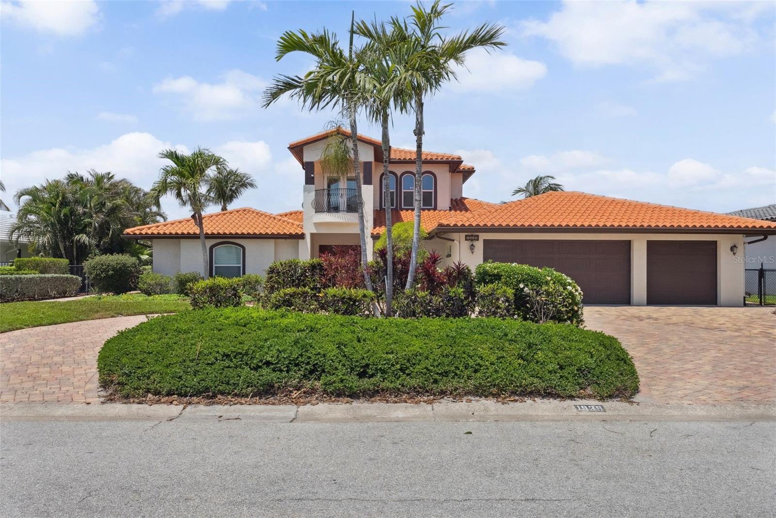 Tropical Waterfront Paradise with Stunning Downtown Views! Welcome to 1939 Hawaii Ave NE, a breathtaking 3-bedroom, 3-bathroom two-story estate nestled in the sought-after Venetian Isles community. This exquisite home offers the perfect blend of luxury, comfort, and panoramic views of downtown St. Petersburg — enjoy the best of both the Bay and the city! Boaters will love the deep sailboat water with a private dock, boat lift, and a newer seawall. Entertain in style from your custom pool area or unwind on the balconies taking in the stunning sunsets and paradise views on clear, sunny days. The chef’s dream kitchen boasts Sub-Zero appliances, gas range, granite countertops, and a spacious center island surrounded by high-end travertine flooring. The elegant living room features a fireplace, perfect for cozy evenings, while hurricane-rated windows provide peace of mind. State-of-the-art tankless gas water heater delivers on-demand hot water throughout the home, blending eco-conscious technology with everyday luxury. A three-car oversized garage with premium storage systems and an oversized paver circular driveway ensures plenty of space for all your toys. The custom front doors make a grand first impression. From the luxurious finishes to the unbeatable location, this home is truly one-of-a-kind. Don't miss your chance to own a slice of waterfront paradise in one of St. Pete’s premier neighborhoods!