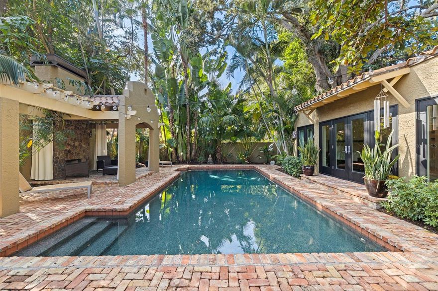 SECLUDED SNELL ISLE RETREAT with 1937 CHARM, IMPACT WINDOWS, PRIVATE TROPICAL POOL & OUTDOOR PAVILION. Slip into a romantic Snell Isle sanctuary where natural light pours in, palm fronds sway outside every room, and life flows effortlessly from indoors to courtyard, patio, and pool, all just a golf-cart ride from Downtown St. Pete.

Set behind wrought-iron gates on one of Snell Isle’s most iconic boulevards, 808 Brightwaters Blvd NE offers a rare blend of timeless 1937 architecture, modern peace of mind, and a welcoming, resort-style lifestyle. A lushly landscaped private courtyard entry creates an immediate sense of arrival and seclusion, and once inside, the home feels warm, airy, and inviting. Sunlight floods the living spaces throughout the day, highlighting travertine floors and giving the entire home a bright, joyful energy.

With 4 bedrooms, 3 baths, and 2,698 square feet, the layout is designed for both comfort and flexibility. One bedroom is perfectly suited as a dedicated office or workout room, while the others offer peaceful retreats. Each bedroom features doors that open to patio areas, creating private outdoor escapes for guests, work-from-home days, or quiet mornings with coffee and birdsong. The kitchen anchors the home with an entertainer’s flow, meaningful recent updates, generous storage, and easy connection to the outdoor living areas.

Out back, the home lives like a private retreat. The yard is a true palm tree arboretum with an extraordinary variety of mature palms and tropical plantings surrounding the pool and cabana, offering rare privacy and a lush, vacation-at-home atmosphere. A covered outdoor pavilion with a fireplace sets the stage for romantic evenings, sunset dinners, and alfresco gatherings year-round.

Smart upgrades add coastal confidence without sacrificing charm: impact-rated doors and windows, a barrel tile roof, HVAC 2019 (main house), new plumbing pipes under the house (2021), driveway to street approach (2020), tankless water heater (2025) with secondary water heater in primary bath (2019), vapor barrier in the crawl space (2025), and premium water-quality systems including whole-house softener/filtration and reverse osmosis (11/2025).

And the location is the finishing move—serene, prestigious, and perfectly positioned near Vinoy Golf Club, Beach Drive, The Pier, museums, dining, shopping, boating, bayfront parks, Albert Whitted Airport, and Gulf beaches. This is Snell Isle at its most romantic and refined: private, light-filled, storm-smart, and designed for the lifestyle that makes this neighborhood one of St. Petersburg’s most coveted.