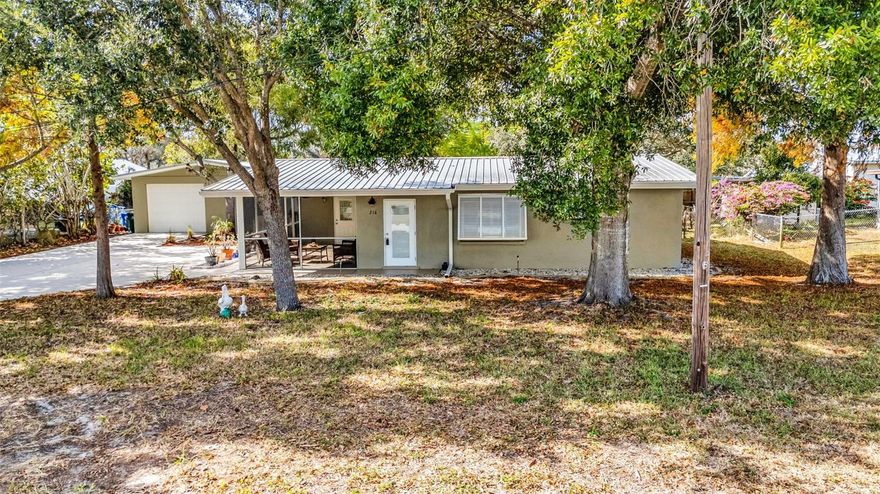 Welcome to this charming 2 Bedroom, 1 Bathroom home with a 4-Car Detached Garage plus Office, perfectly situated on an oversized lot in Port Charlotte. NO HOA FEES! CLICK ON THE VIRTUAL TOUR LINK 1 FOR THE VIDEO AND VIRTUAL LINK 2 FOR THE 3D TOUR. A welcoming screened front porch offers ample space for seating—ideal for enjoying morning coffee or greeting neighbors. Inside, you’ll find tile flooring throughout complemented by classic Bahama shutters, creating a bright and breezy Florida feel. The living room flows seamlessly into the eat-in kitchen, making everyday living and entertaining effortless. The EAT-IN kitchen features all appliances, solid surface countertops, abundant cabinetry for storage, and a convenient breakfast bar. Both bedrooms are generously sized with a shared bathroom with a pedestal sink and walk-in shower nearby. French doors open to a screened-in lanai, the perfect spot to relax with your favorite evening beverage while taking in the peaceful backyard setting. The large, fully fenced backyard boasts mature landscaping and easy access to the detached garage. The 4-car garage with office space offers endless possibilities—ideal for car enthusiasts, hobbyists, contractors, boat or motorcycle storage, a home-based business, workshop, art studio, gym, or additional storage for all your toys! Conveniently located close to US-41, I-75, and local favorites such as Fishermen's Village, Sun Seeker Resort, Ponce De Leon Park, shopping & boutiques, walking & bike trails, fine & casual dining, LIVE entertainment, and award-winning beaches! Schedule your showing TODAY!