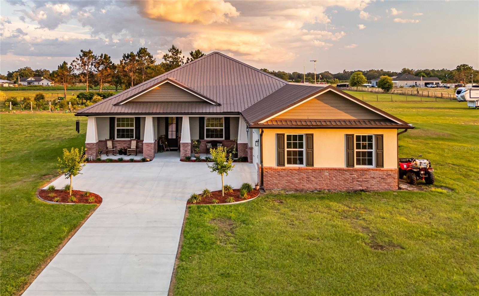 Discover Modern Country Living at Its Finest! Built in 2022, this stunning 4-bed, 3-bath, 2,390 sq. ft. American Traditional home on a private gravel lane in Plant City blends luxury with self-sufficiency. Enjoy a gourmet kitchen, custom stone-topped cabinets in the dining room and 4th bedroom (perfect as an office), and a screened paver patio with roof for outdoor bliss. A 26’x50’ metal garage with roll-up doors, whole-home generator, dual RV hookups (one full), and two 275-gallon water tanks ensure versatility and preparedness. Grow your own food with fruit trees, an underground irrigation system, and a 21’x21’ enclosed chicken coop. Hardwired security cameras, hurricane shutters, and no HOA provide peace of mind and freedom. Nestled in a neighborly community with top schools and easy Tampa access, this move-in-ready gem is perfect for families, hobbyists, or RV enthusiasts. Seize your slice of Florida paradise—schedule a tour today!